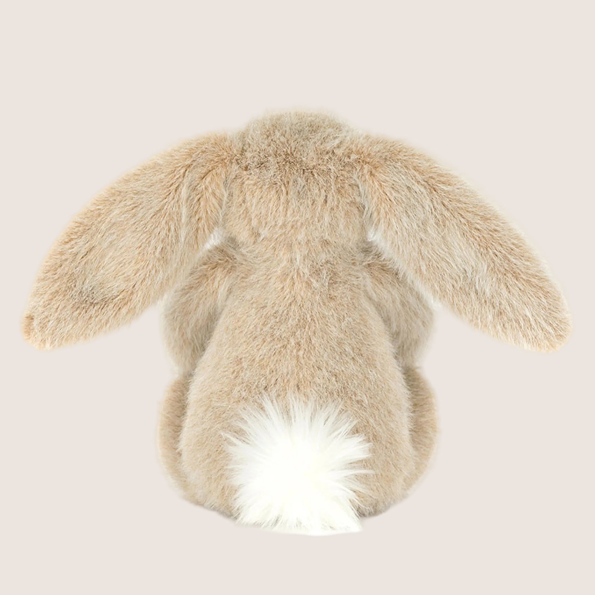 A tan fuzzy bunny shaped stuffed animal. 