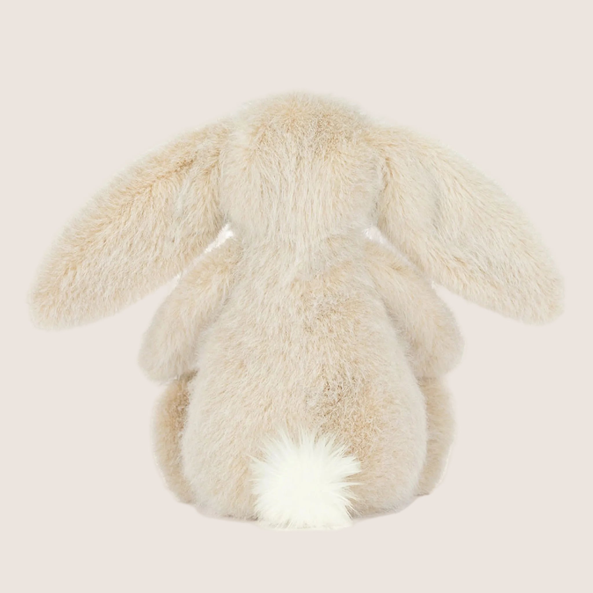 An ivory fluffy bunny stuffed animal.