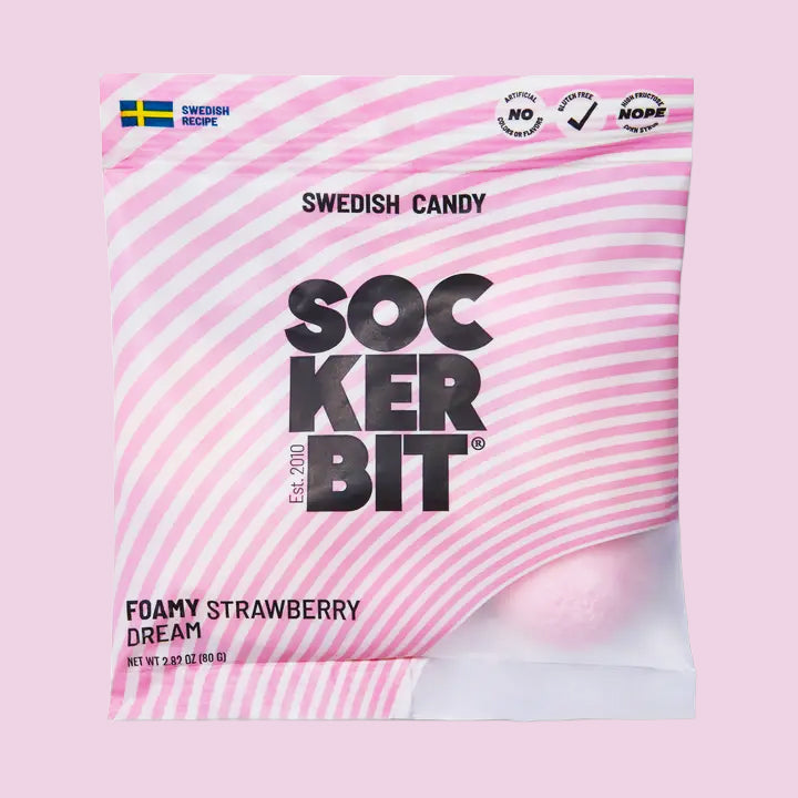 Bag of Sockerbit Swedish Candy ‘Foamy Strawberry Dream’ with pink striped packaging and a strawberry foam candy visible inside.