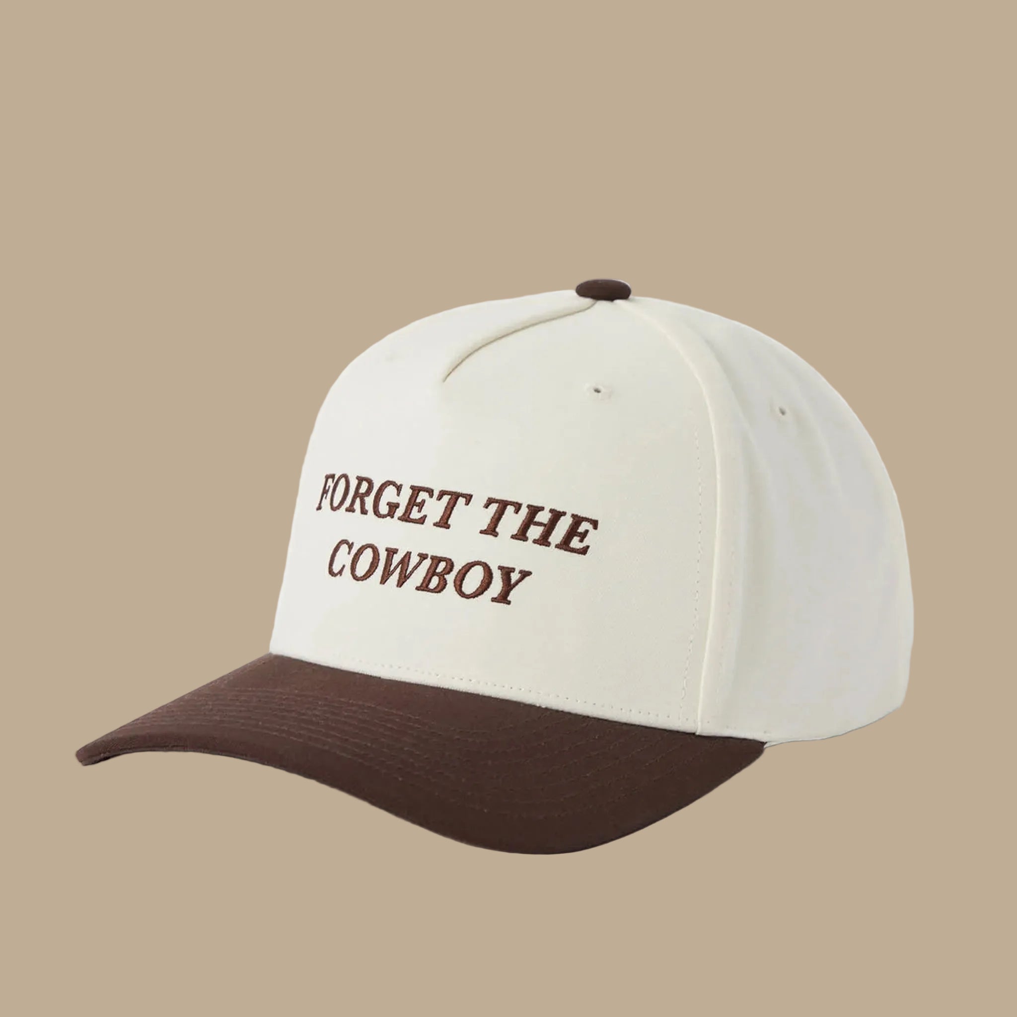 A white and brown two-toned snapback that reads, "Forget The Cowboy". 