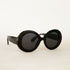 A black round pair of sunglasses. 
