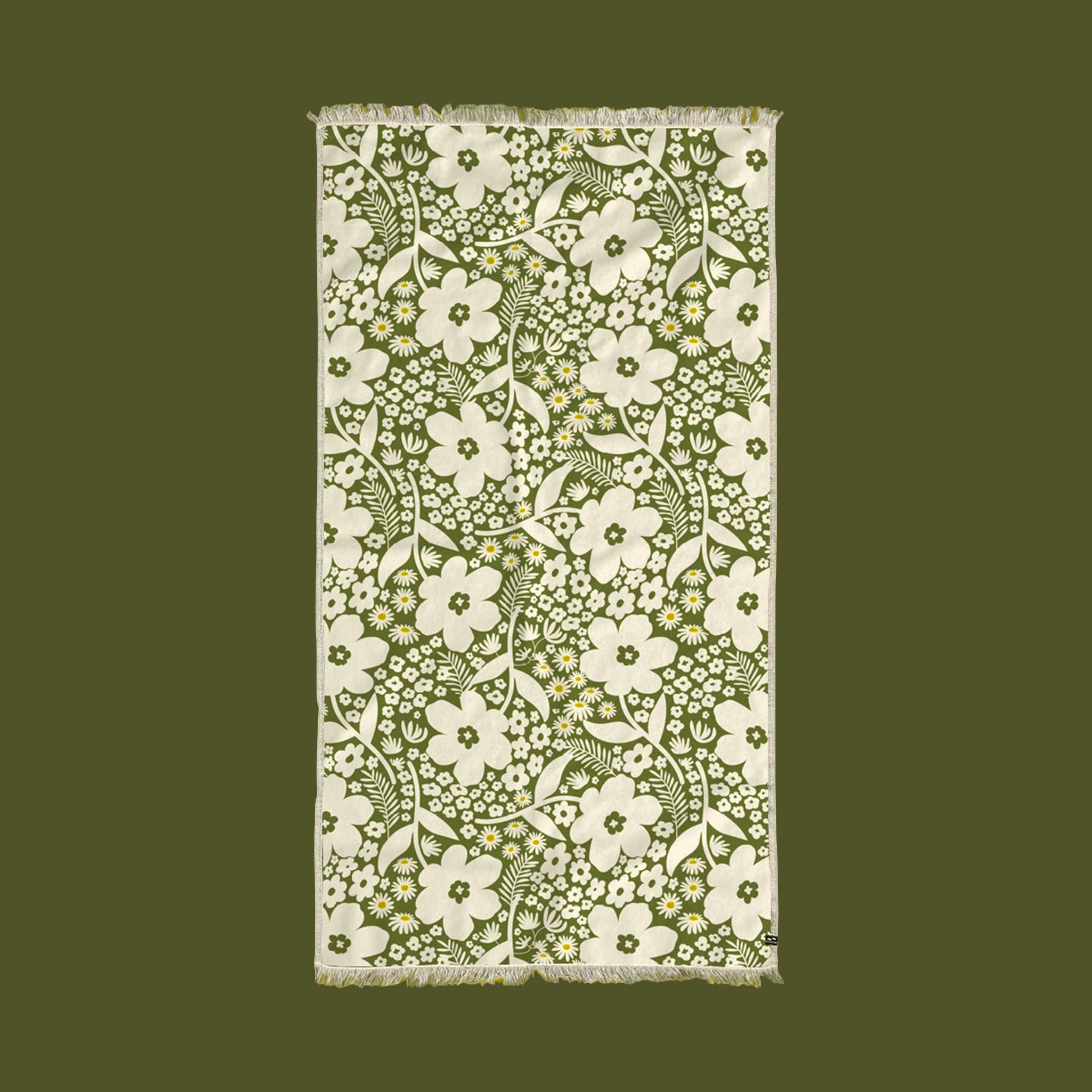 A green and white floral print beach / pool towel. 