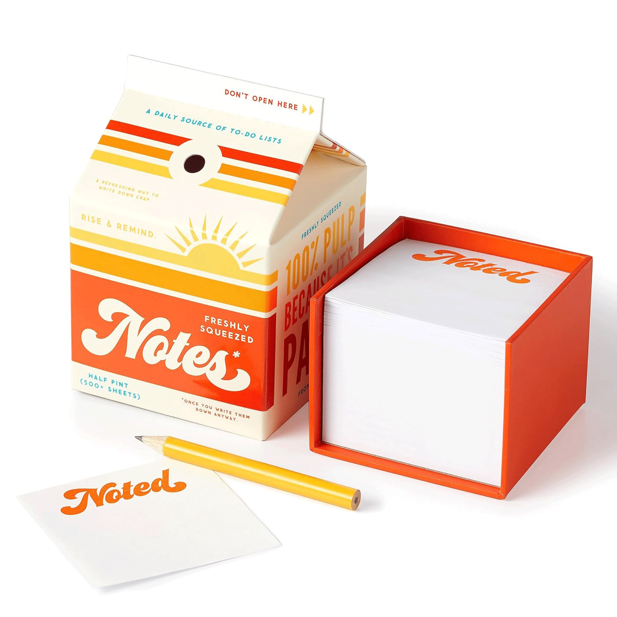 On a white background is a juice carton shaped note pad box with a pencil that is stored in the "straw hole". 