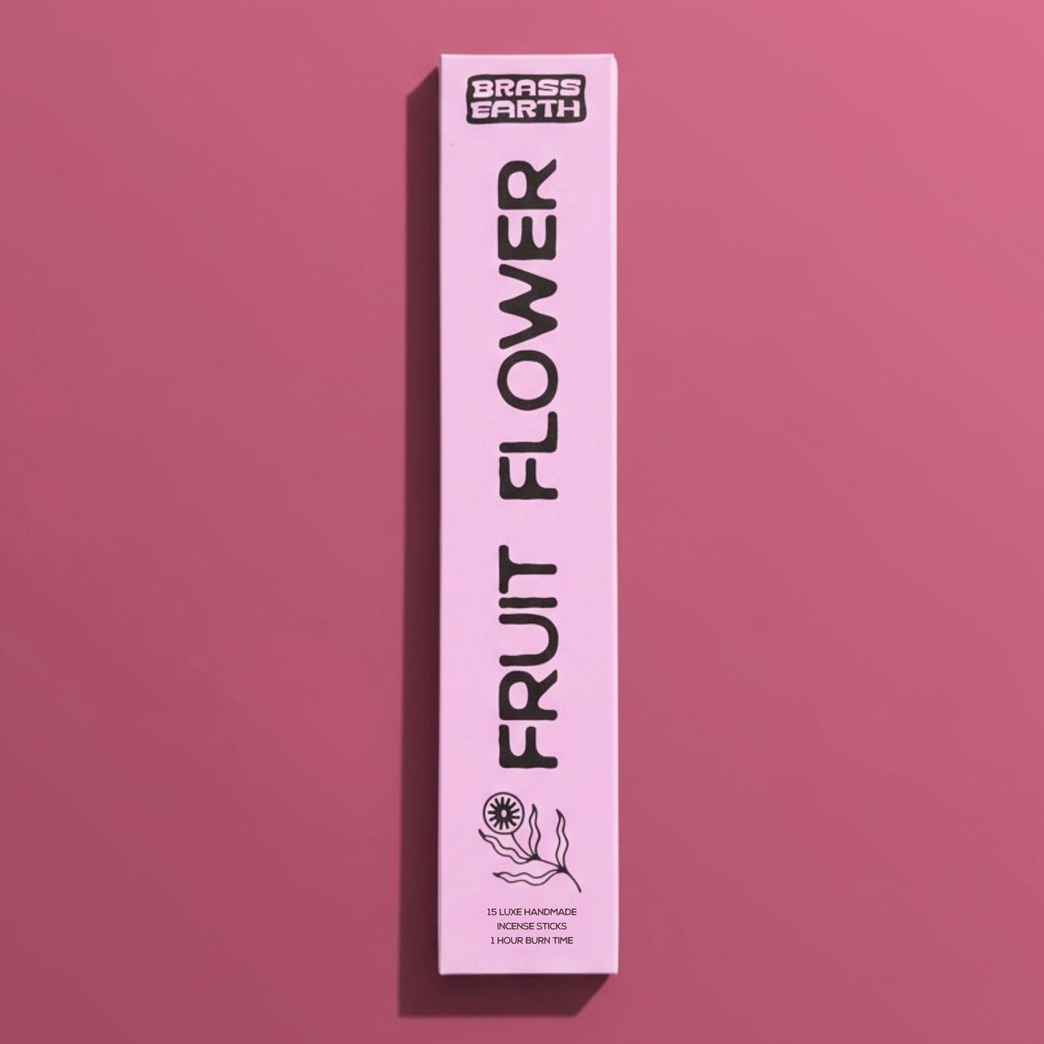 Pink box of 'Fruit Flower' by Brass Earth on a pink background