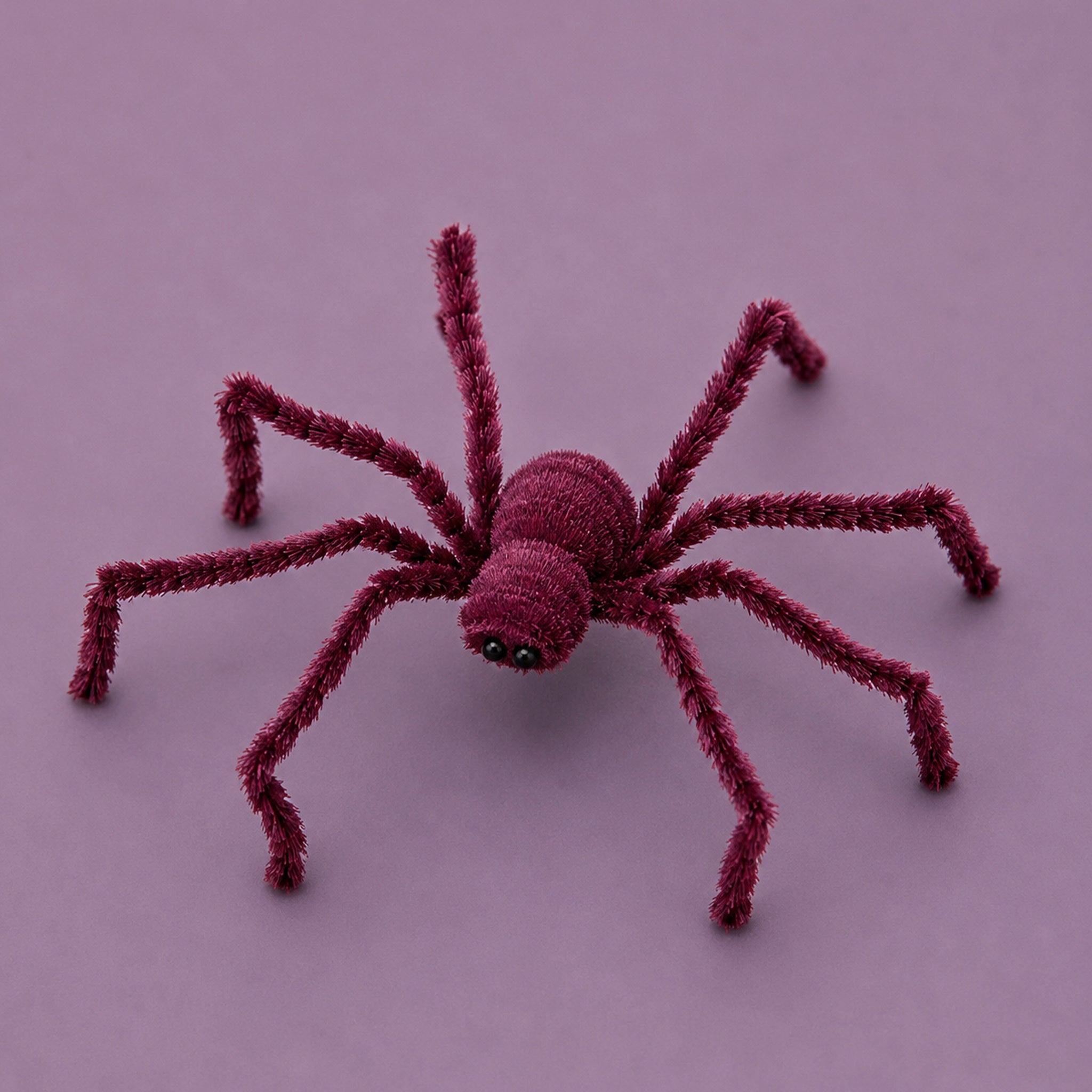 A plum colored spider decoration. 