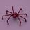 A plum colored spider decoration. 