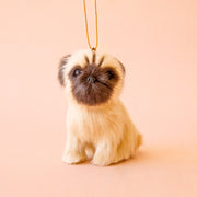 A light tan and brown furry pug ornament. 