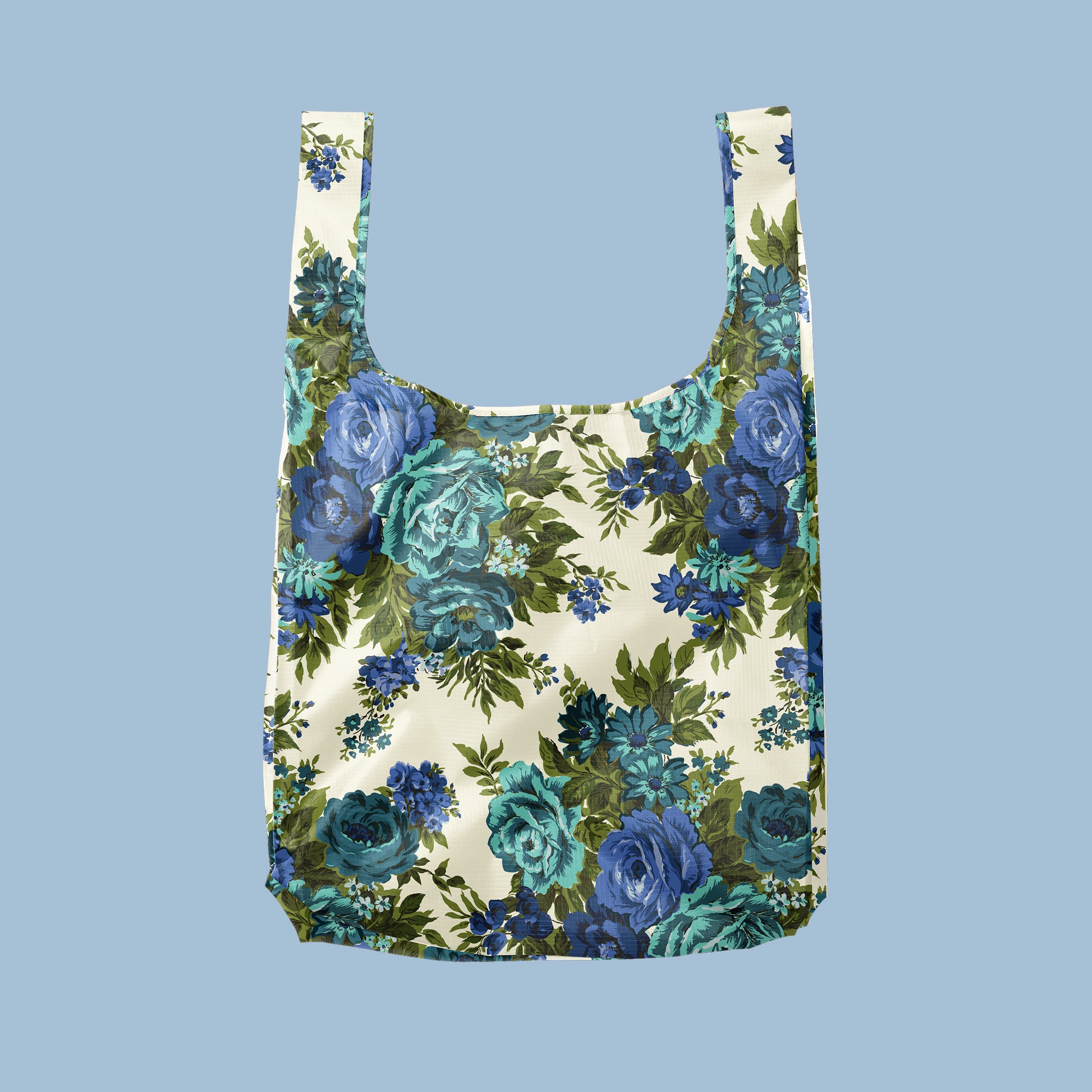 A blue rose floral motif printed on a reusable tote on a blue background.