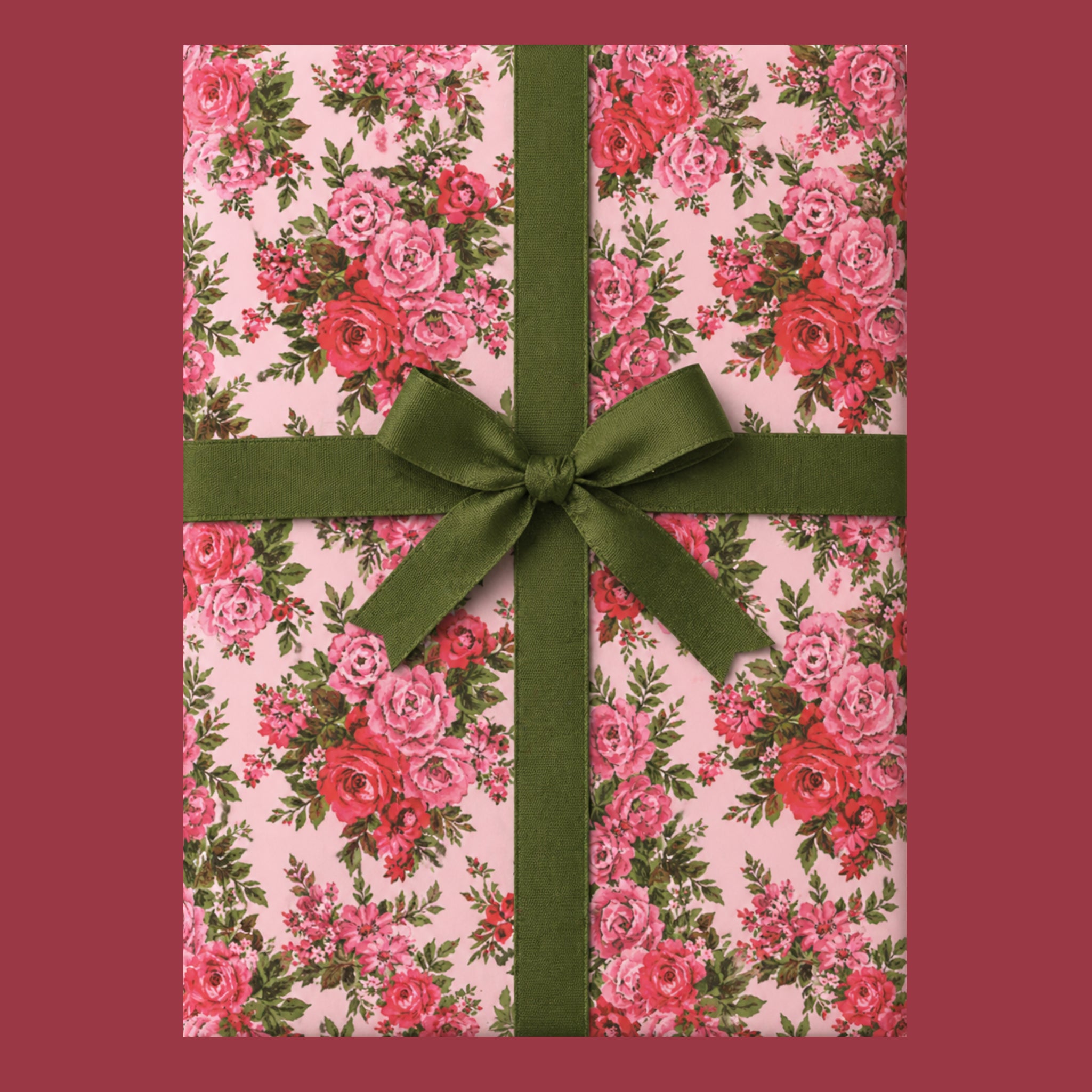 A beautiful vintage pink floral rose gift wrapped box with a green bow.