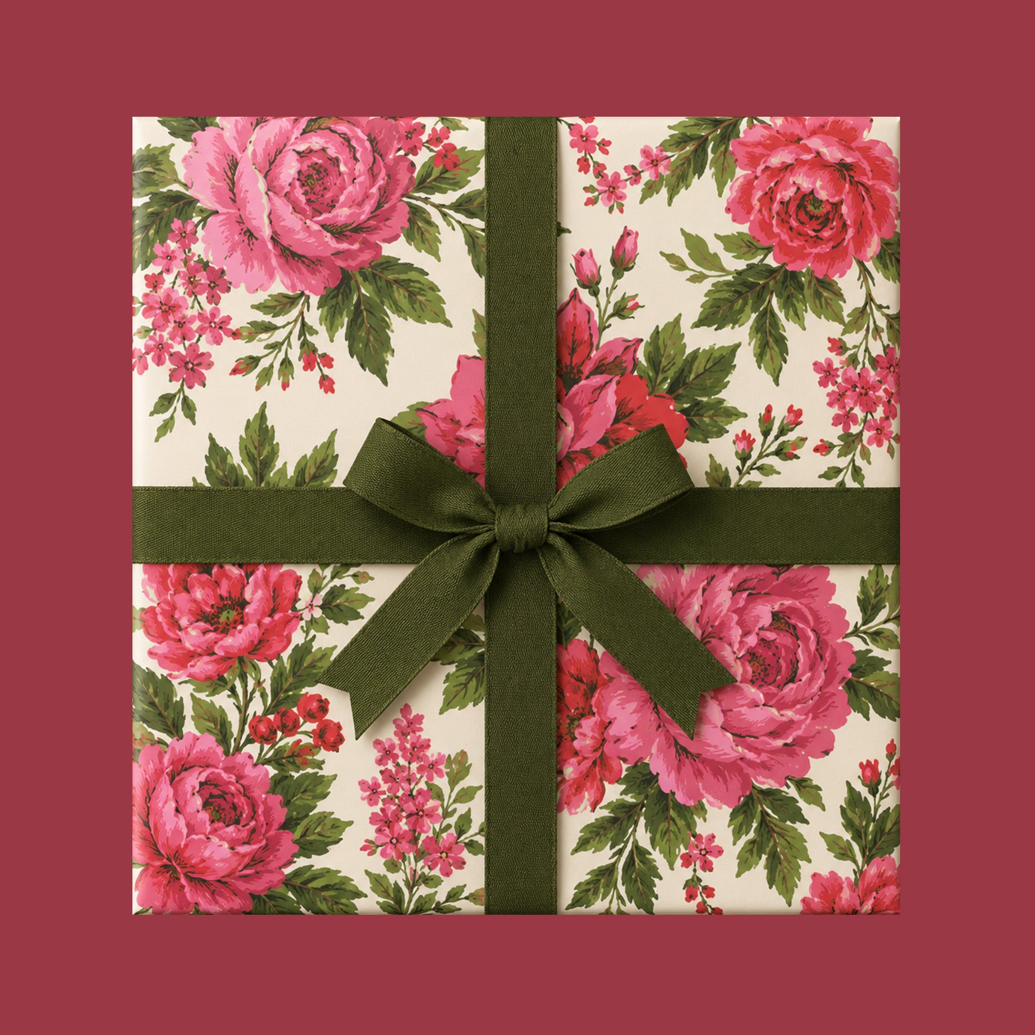 A beautiful vintage pink floral rose gift wrapped box with a green bow.