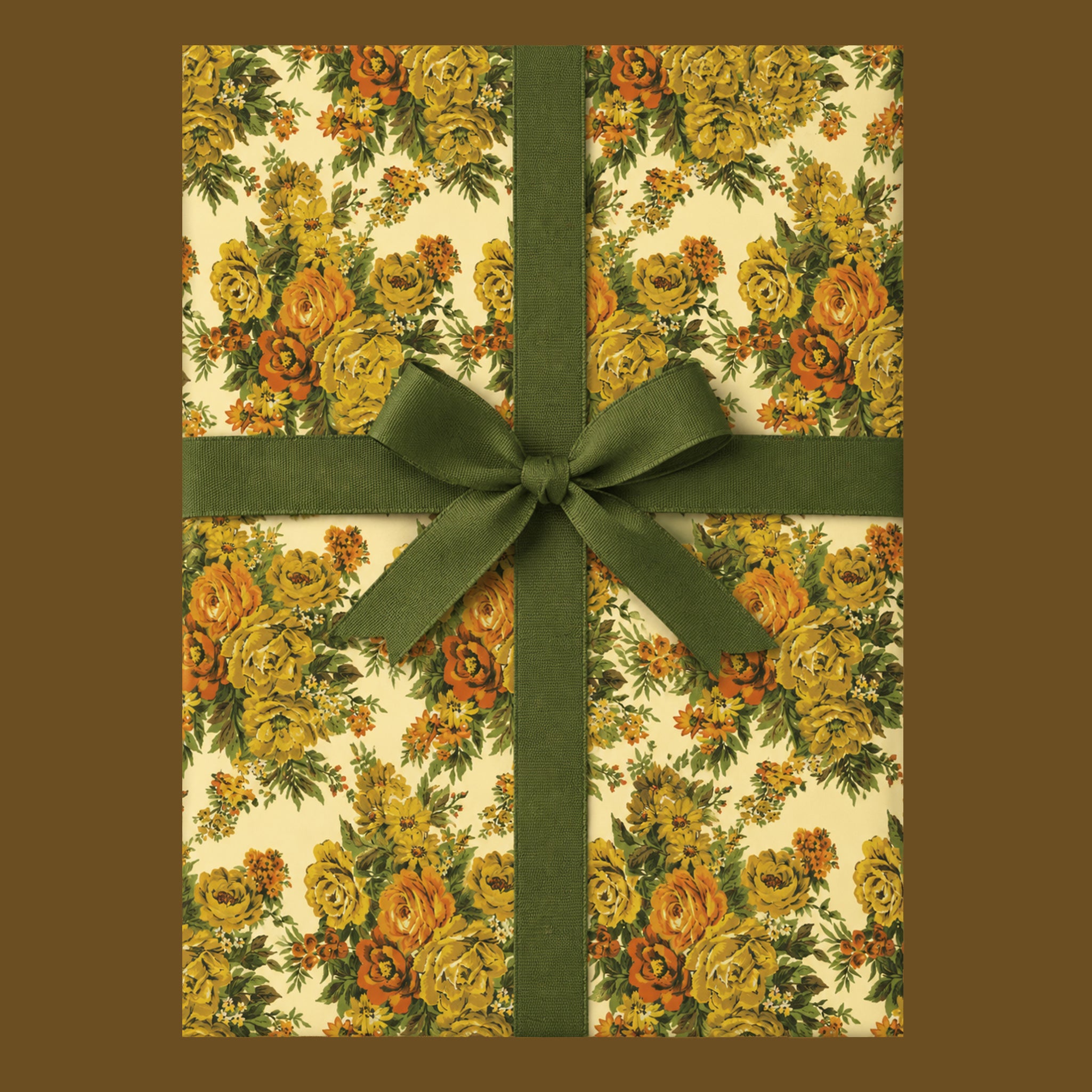 A present wrapped in a vintage yellow rose floral wrapping paper with green ribbon.