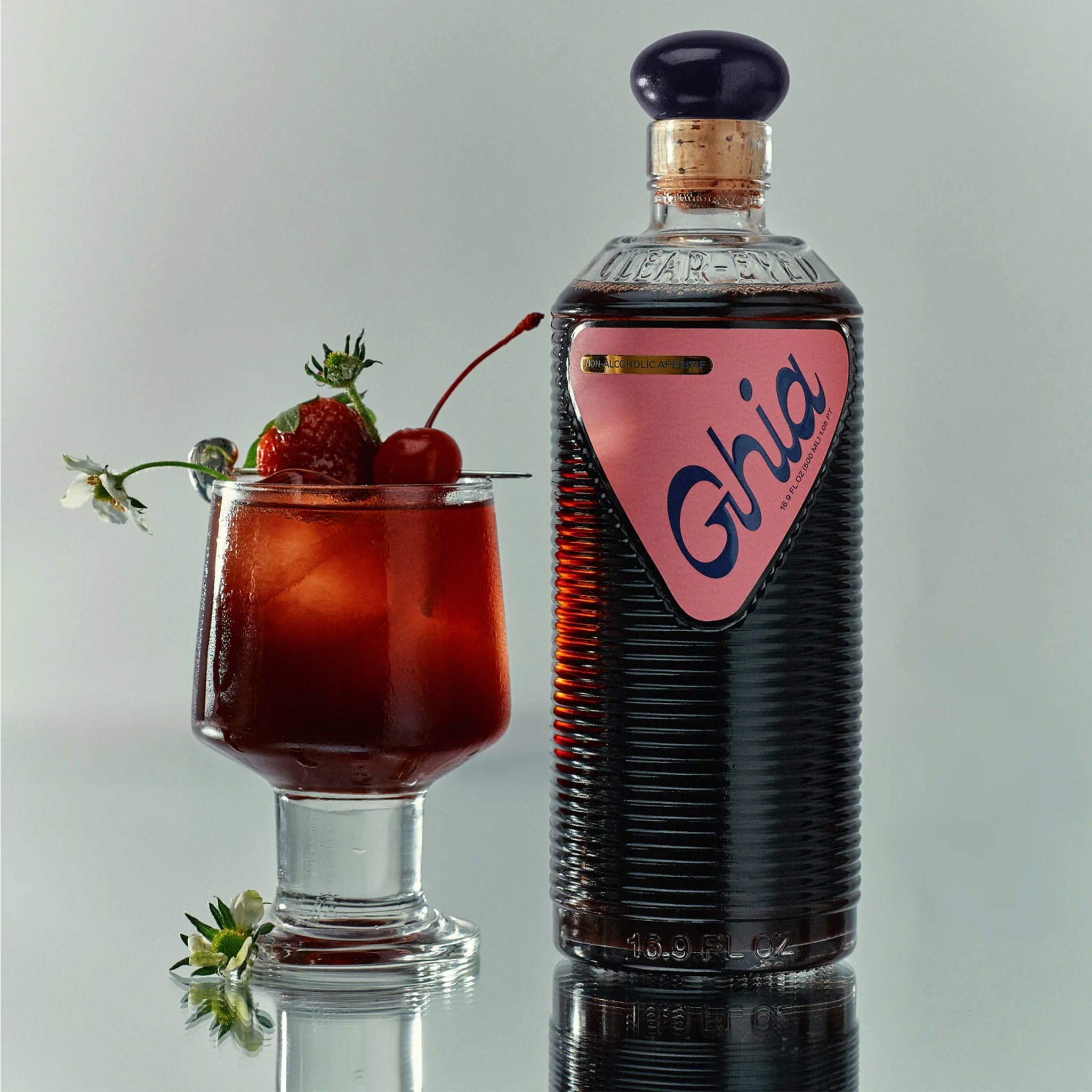 A bottle of berry flavored apertif with a label that reads, "Ghia". 