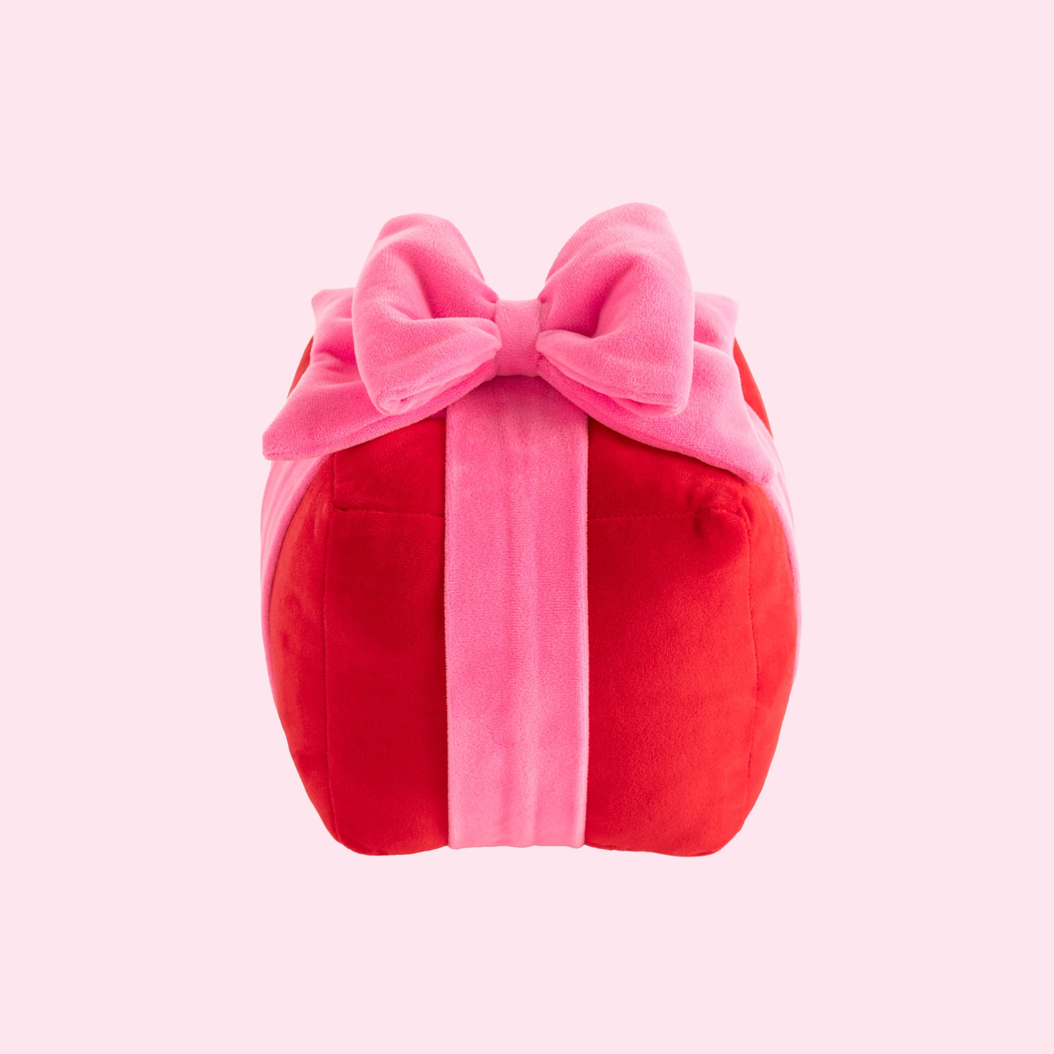 A red and pink present shaped pillow.