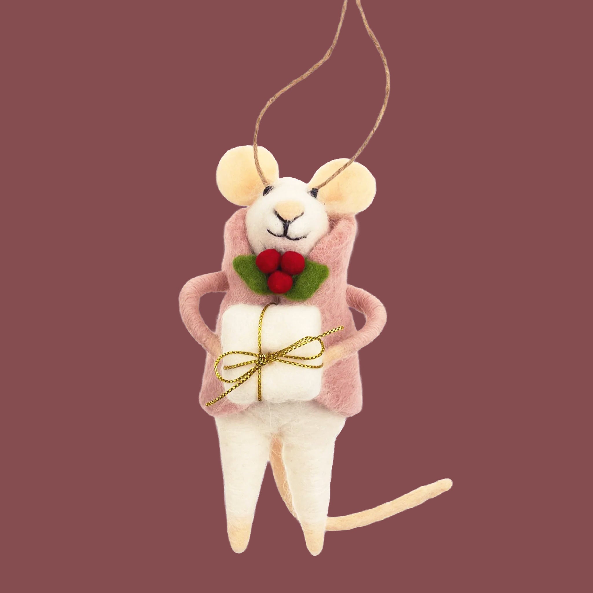 Mouse ornament with a pink coat on. She has a present in hand and has a holly berry on her coat. 