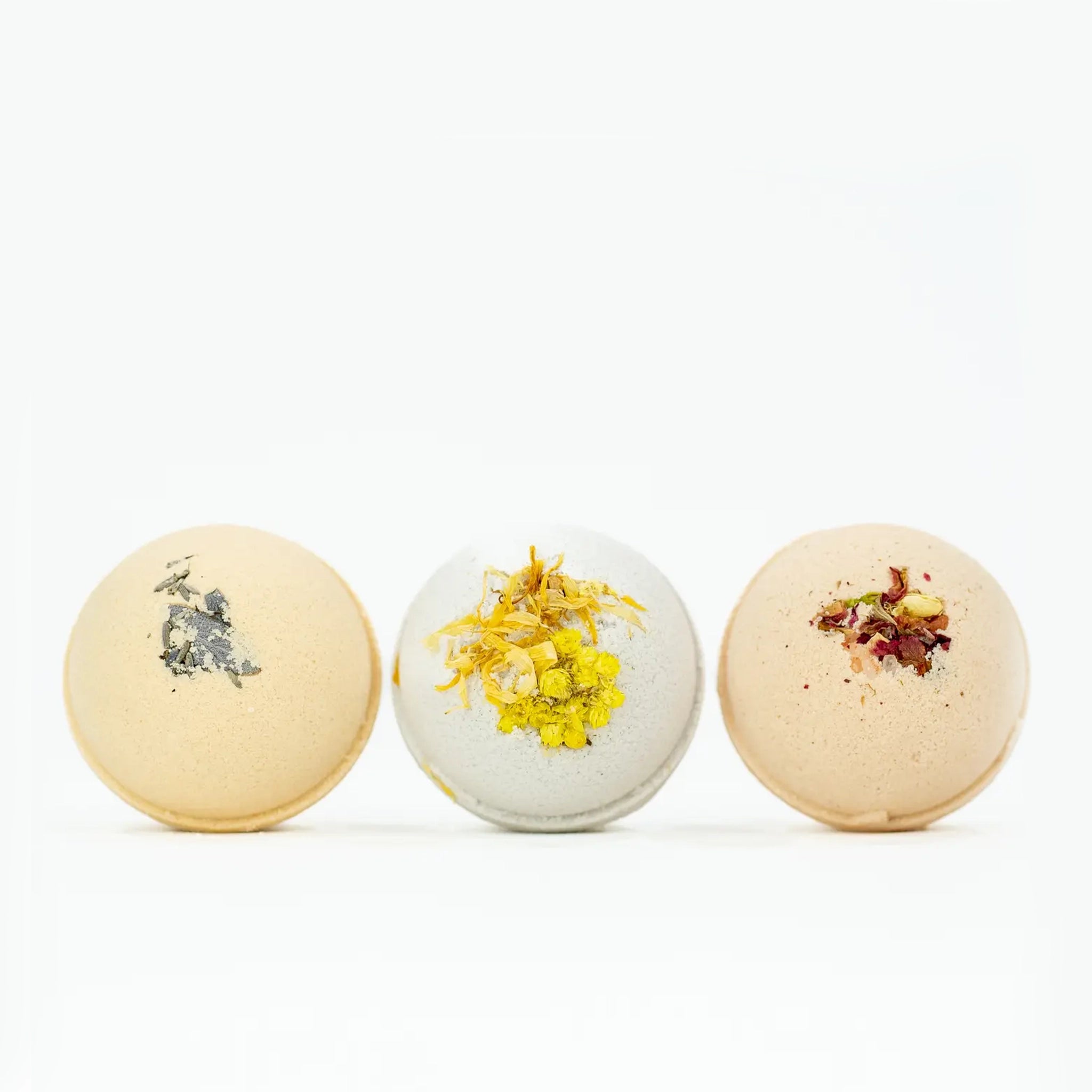 Three bath bombs out of their box in different scents also available on our website. 