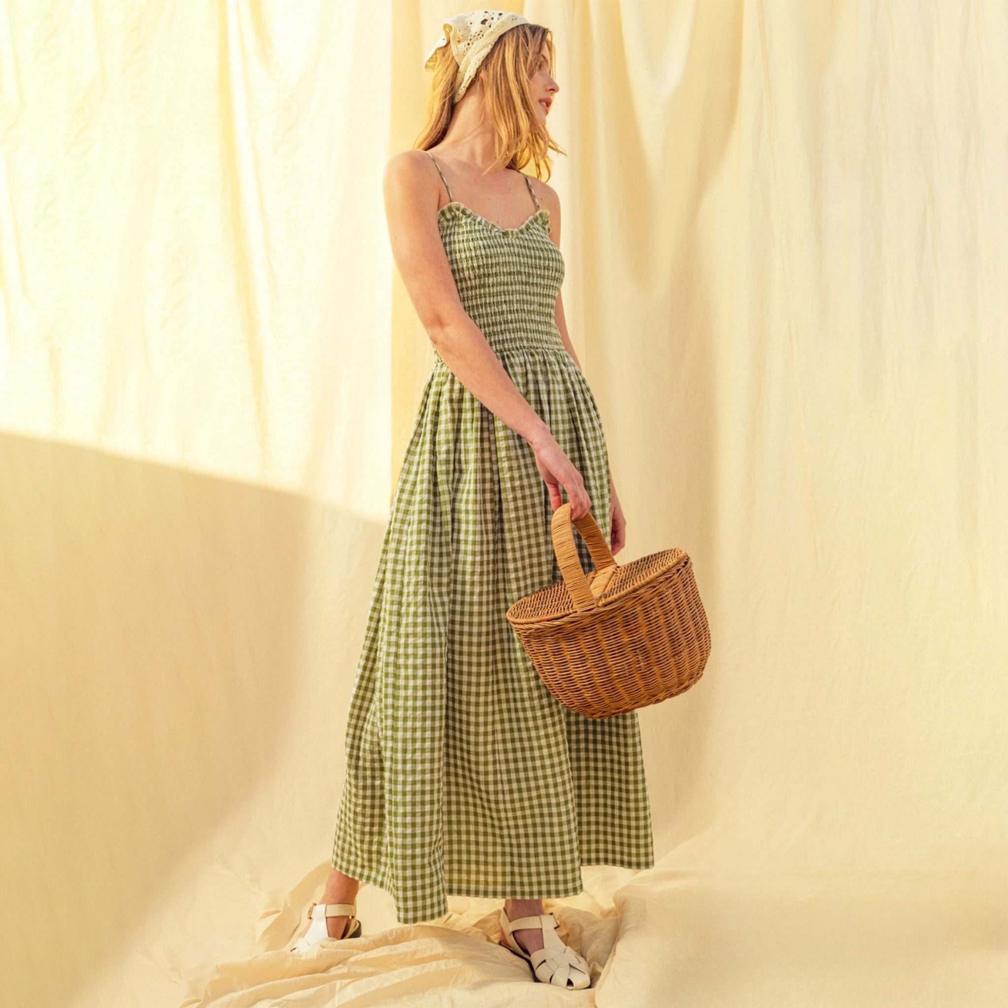 A green and white gingham print maxi dress with spaghetti straps. 