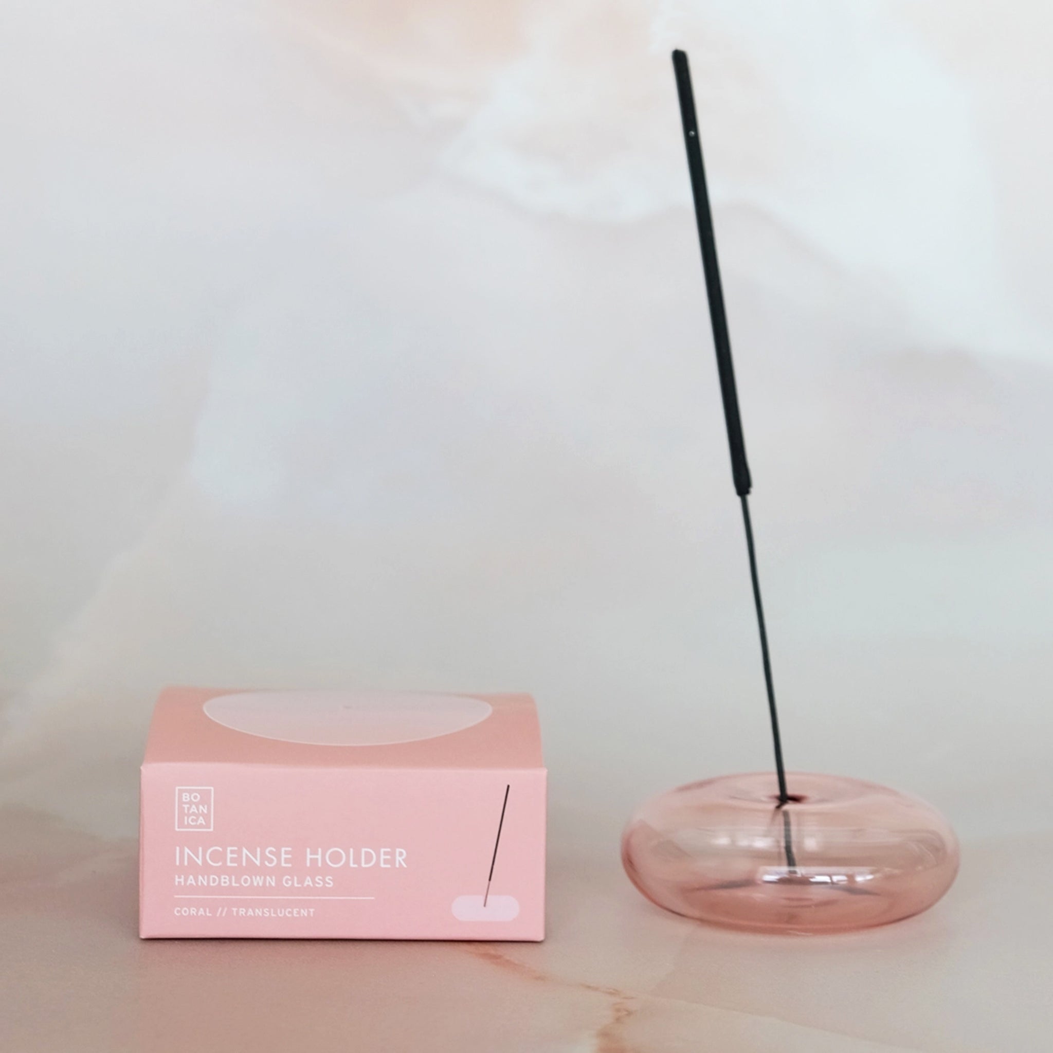 A coral pink bubble shaped incense holder. Incense not included. 
