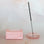 A coral pink bubble shaped incense holder. Incense not included. 