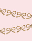 A garland made of gold glitter bow shaped paper cutouts. 