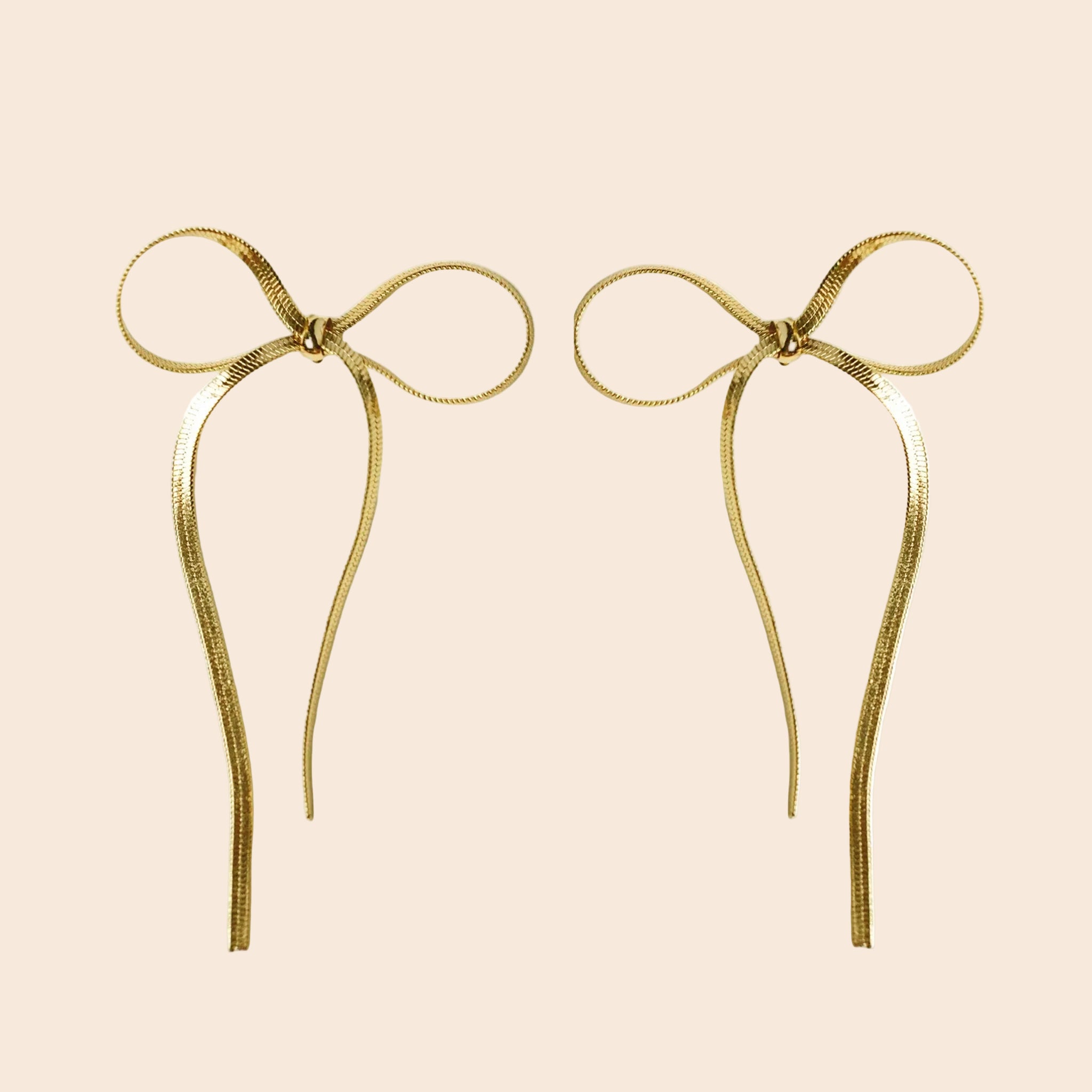 A pair of dangle bow shaped snake chain earrings. 