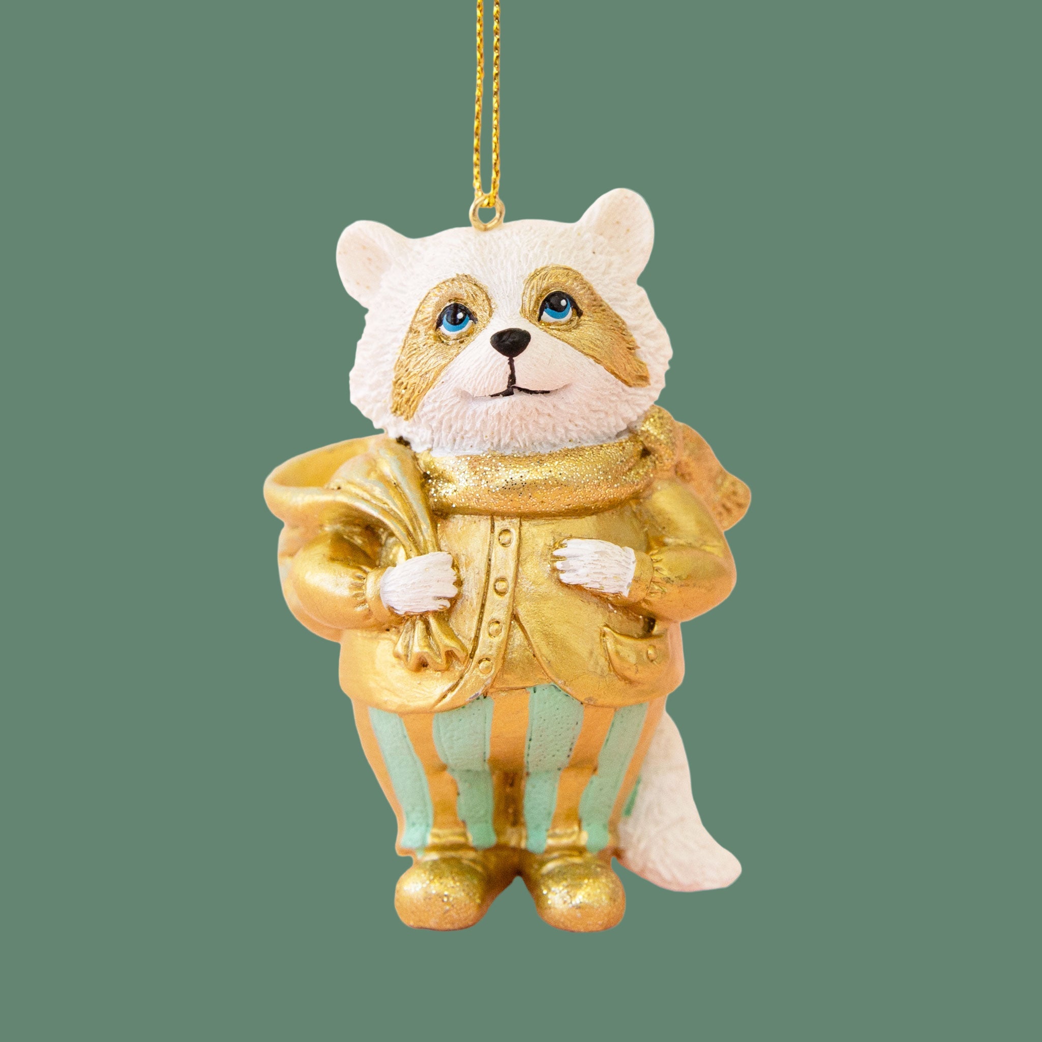 Raccoon ornament with white fur, gold clothes with teal accents. 