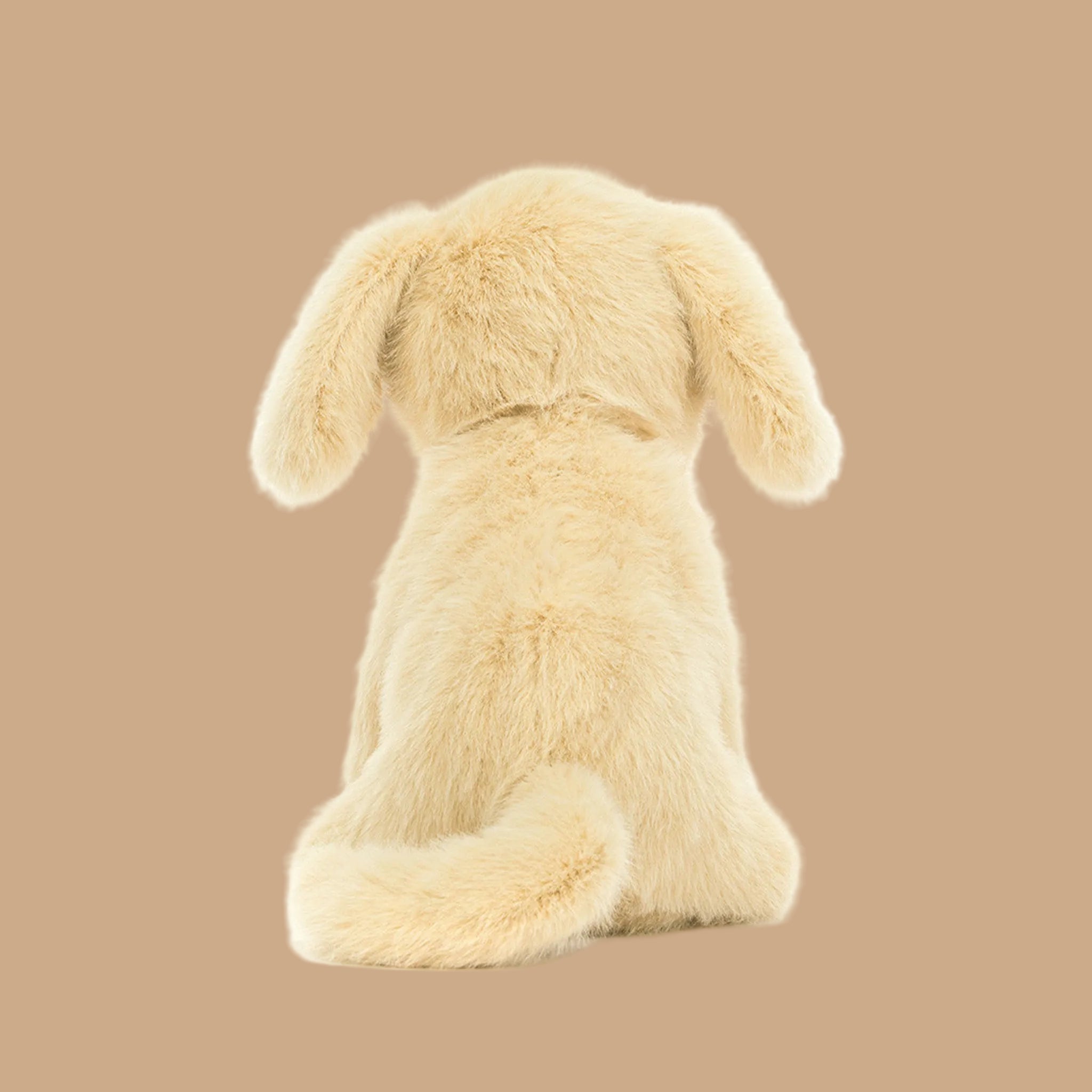 A yellow/tan golden puppy shaped stuffed animal. 