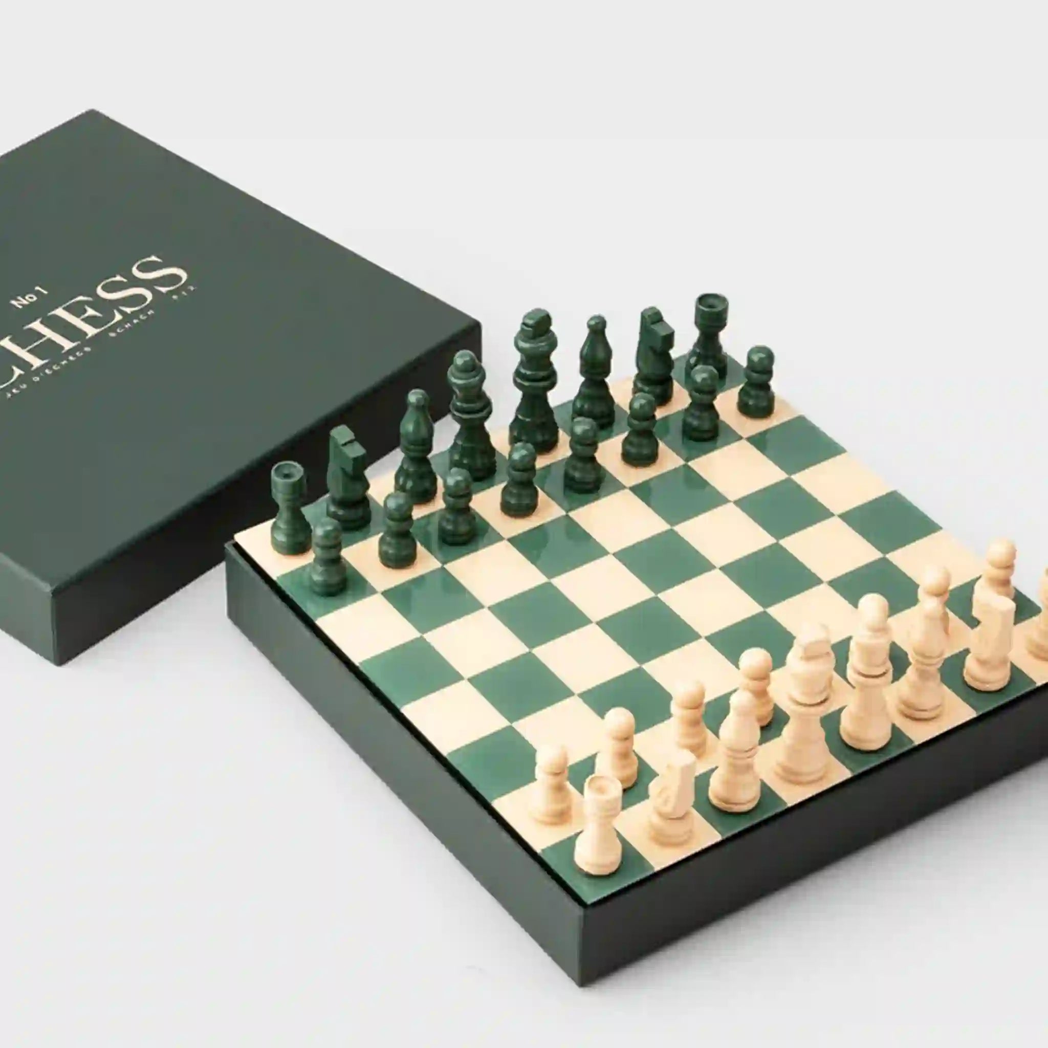 A green and cream colored chess board set.