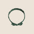 A green baby bow headband with white floral print. 