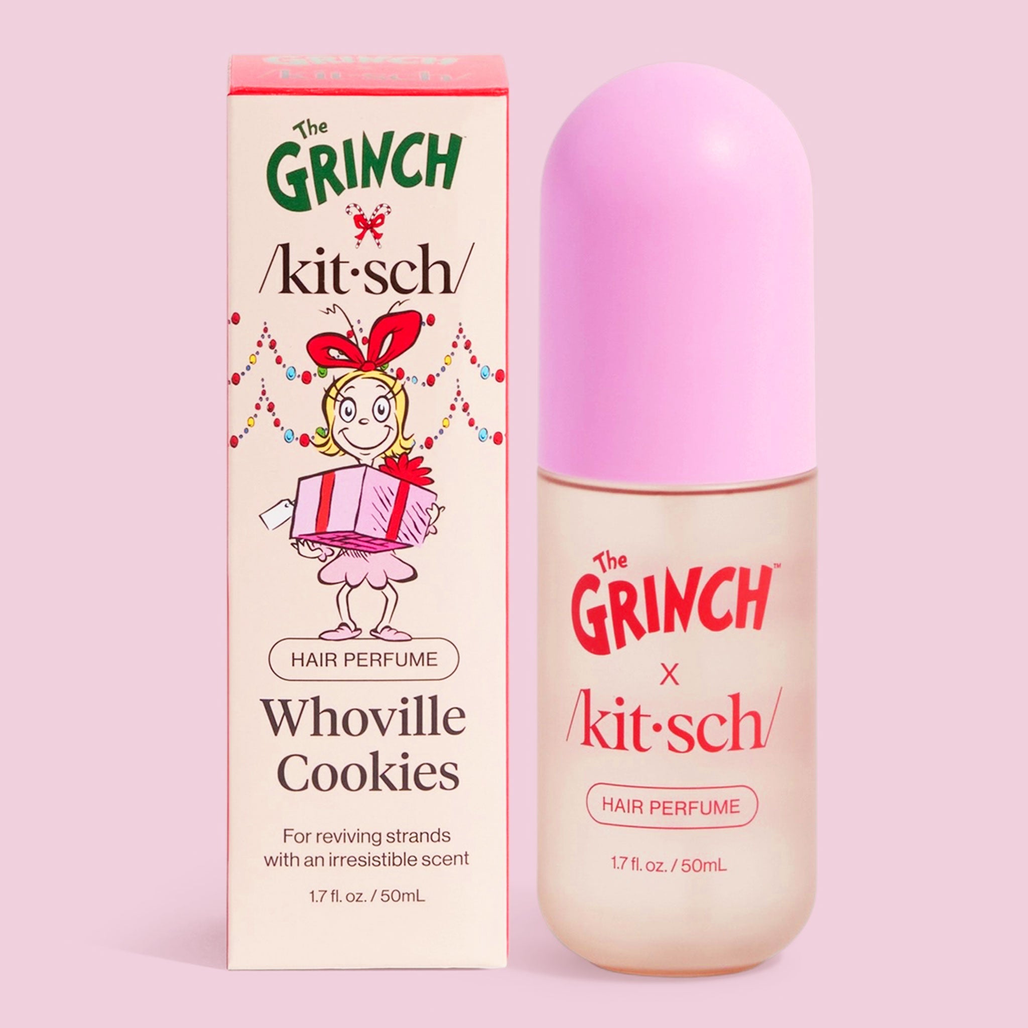 Product photo of ‘The Grinch x Kitsch’ Whoville Cookies hair perfume: a tall cream-colored box with a cartoon character holding a present beside a frosted bottle topped with a pastel pink cap, both on a light pink background.