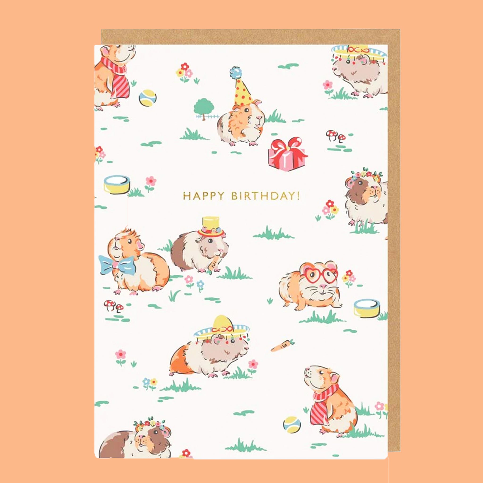 On an orange background is a white card with graphics of guinea pigs dressed up in different party hats  and gold foiled text in the center that reads, "Happy Birthday!". 