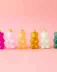 A variety of gummy bear shaped ornaments in different colors. 