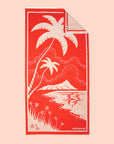 A beach towel with a palm tree design.