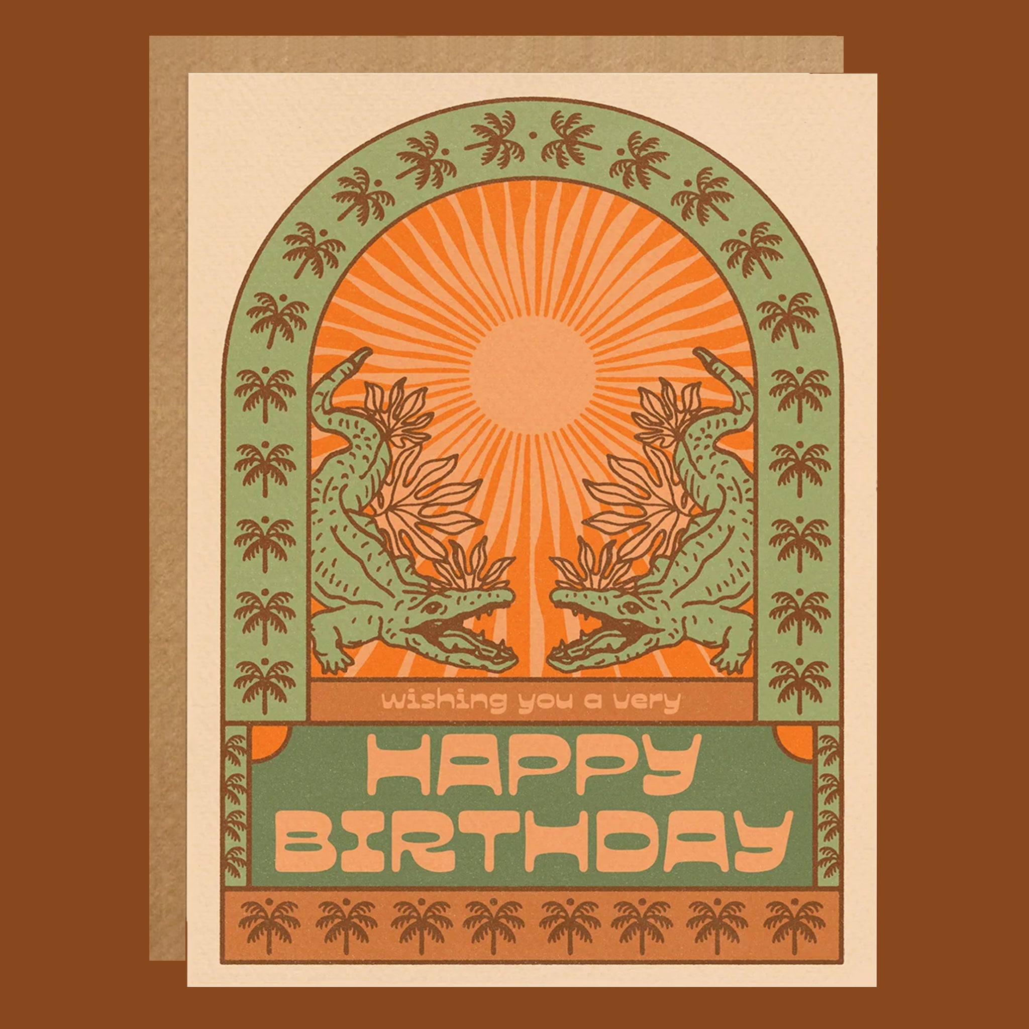 Birthday card with two green creatures and a sun design on a brown background