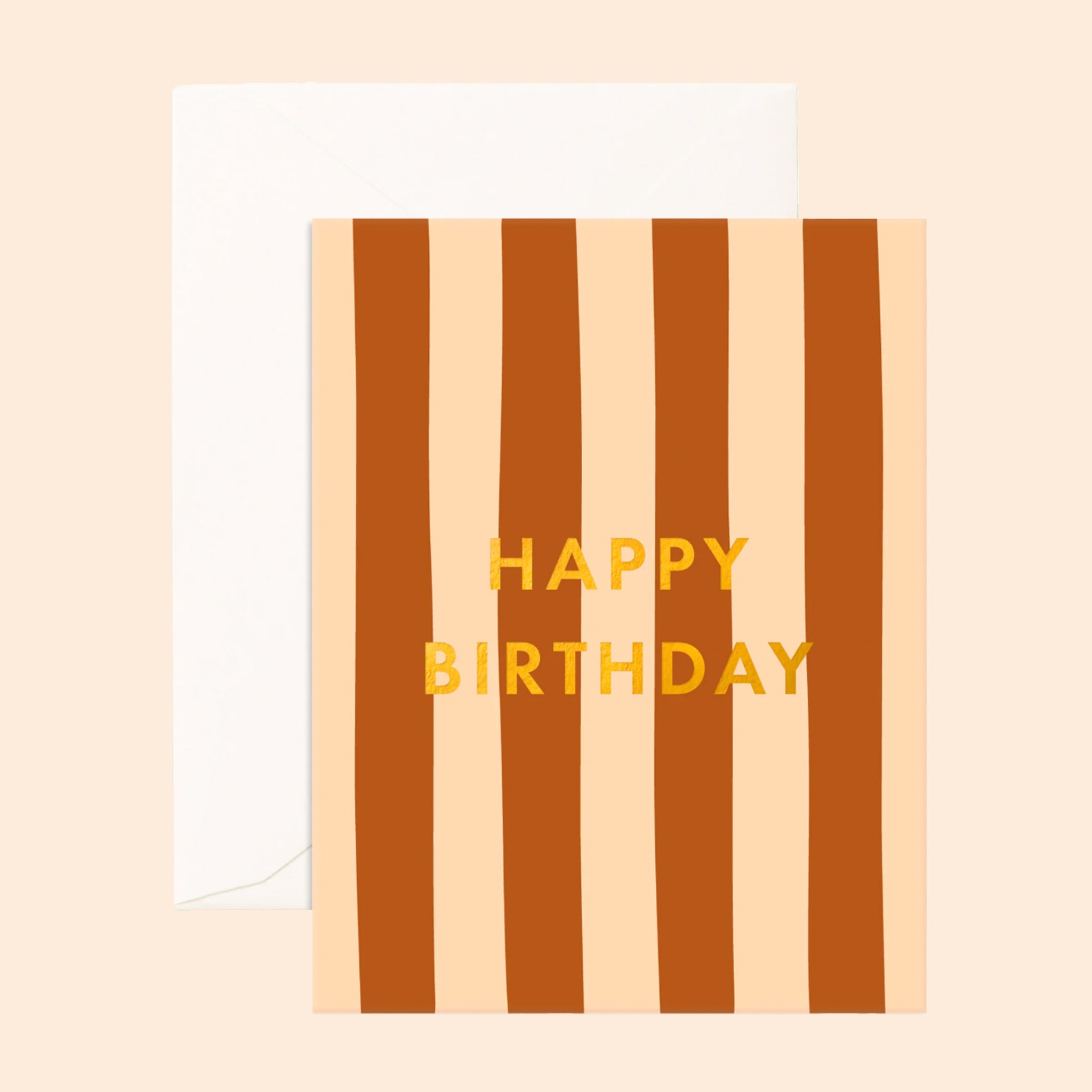 A peach and rust colored card with gold foiled text that reads, "Happy Birthday". 