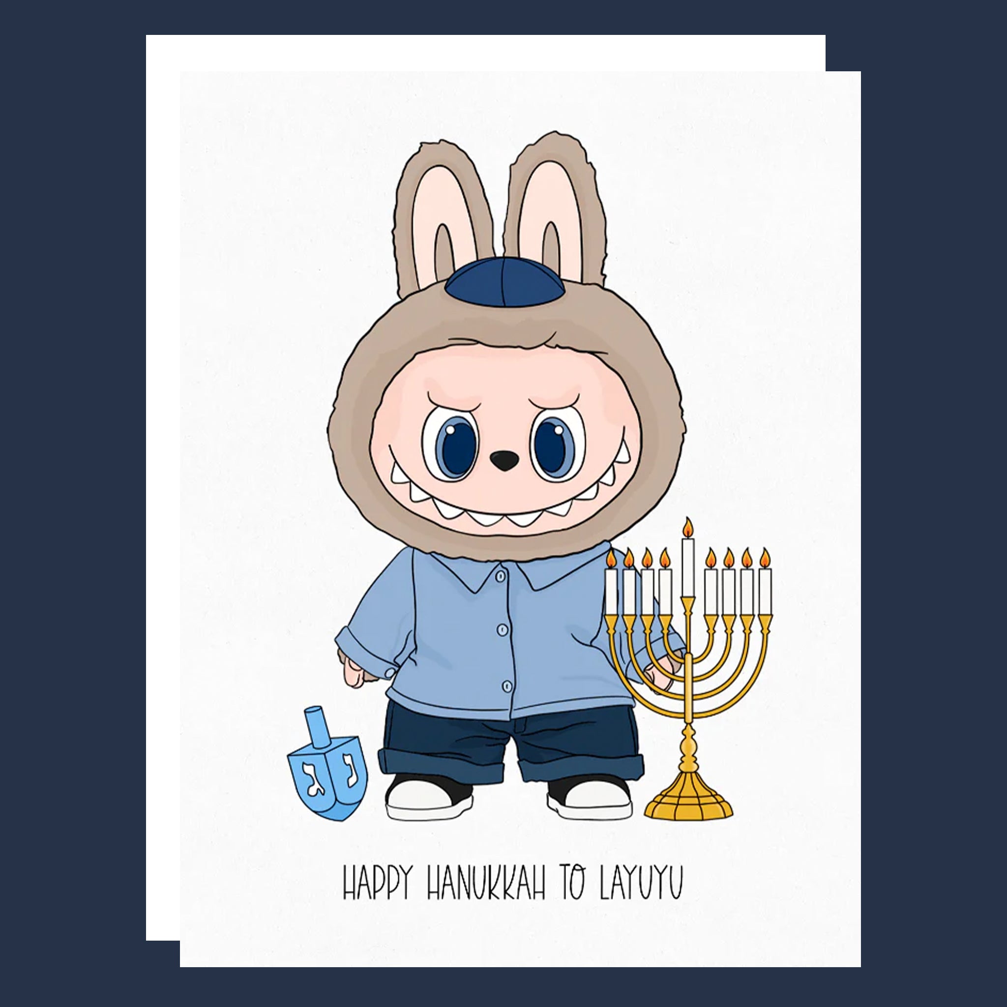 A white card that reads, 'Happy Hanukkah To Layuyu' with a graphic of a Labubu character next to a menorah. 