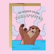 On a pink background is a pink and purple card with an illustration of an otter with text arched above that reads, "So Happy To Be Your D'Otter". 