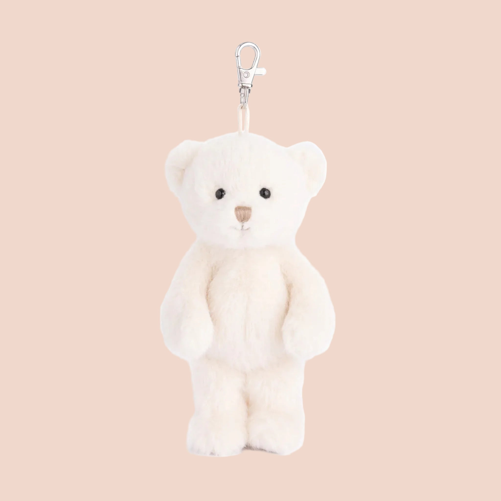 A white bear shaped stuffed toy keychain. 