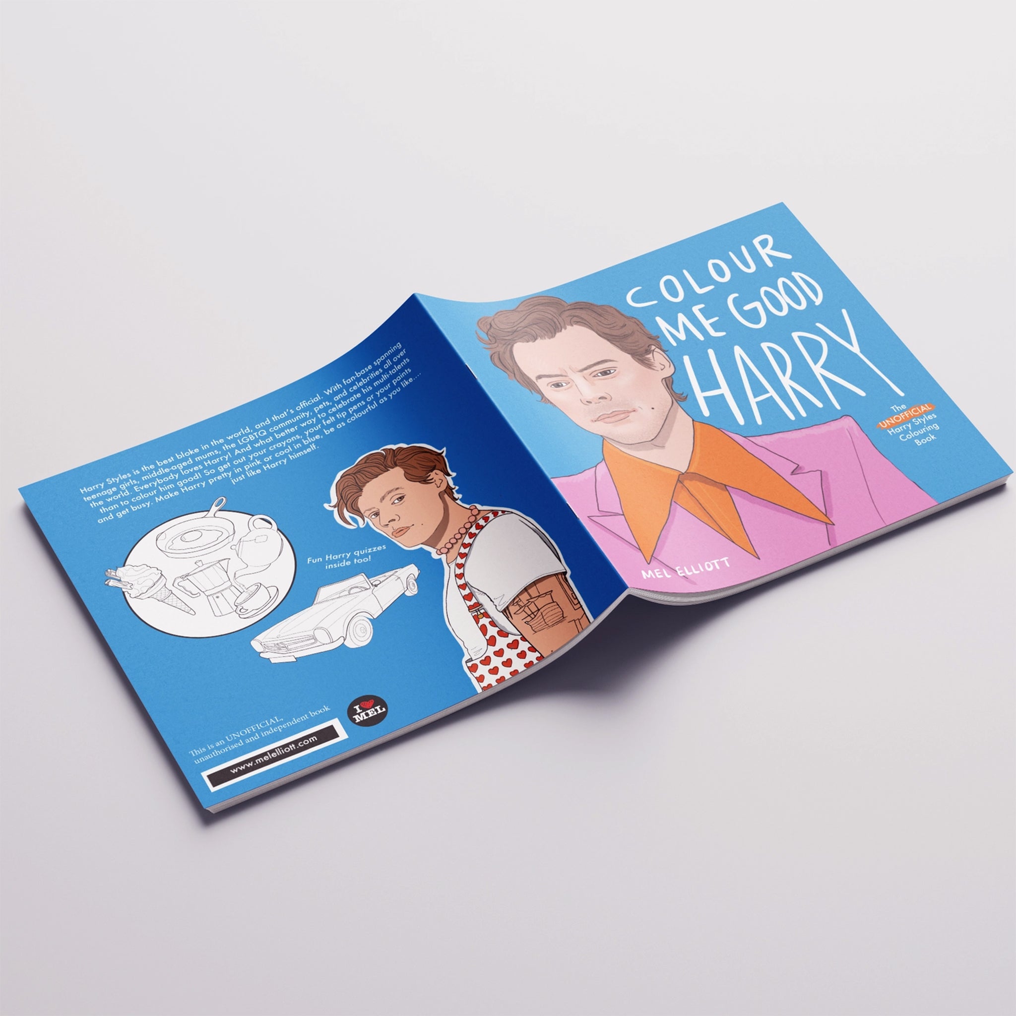 On a grey background is a blue coloring book cover with an illustration of Harry Styles and text that reads, &quot;Colour Me Good Harry&quot;.