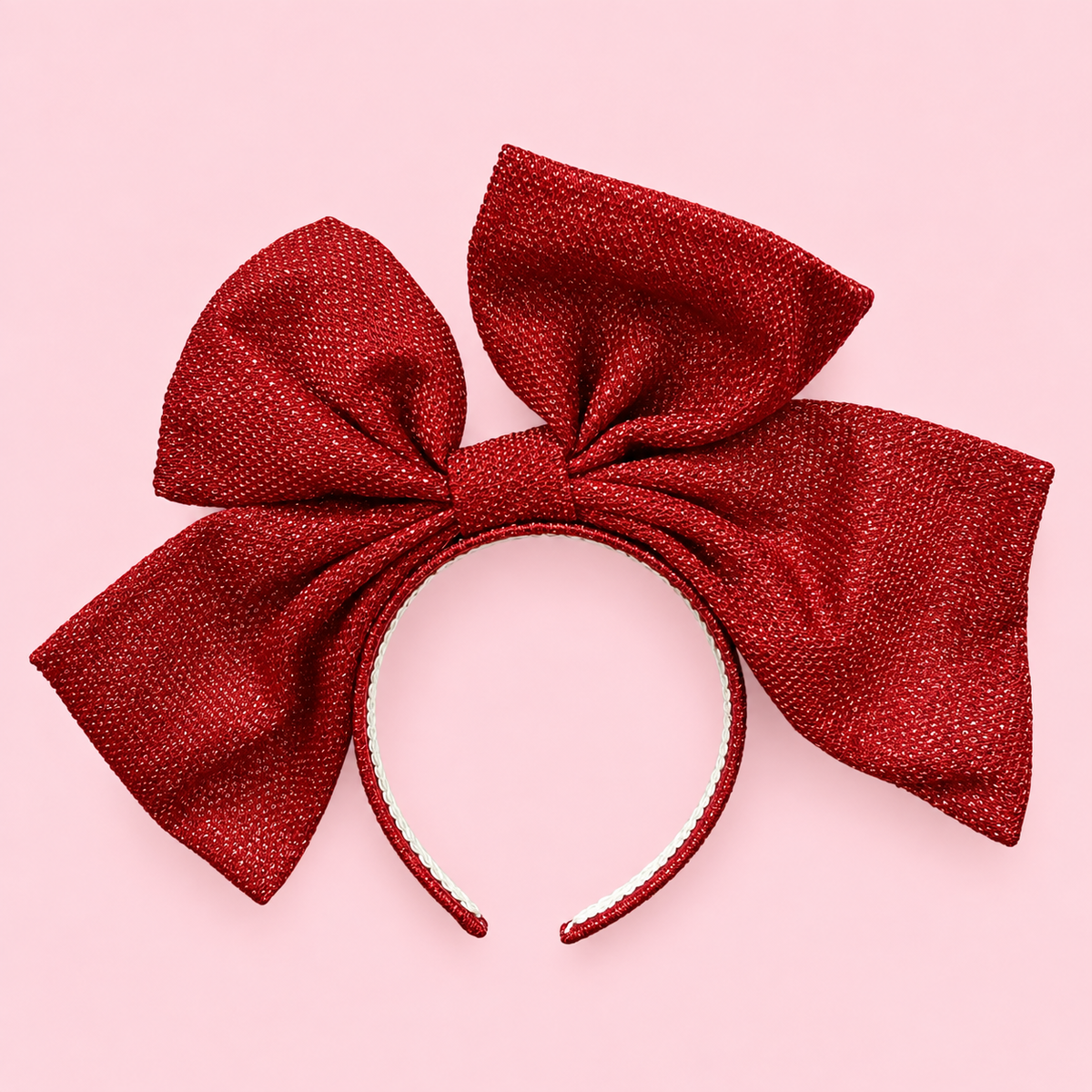 a red oversized bow headband.