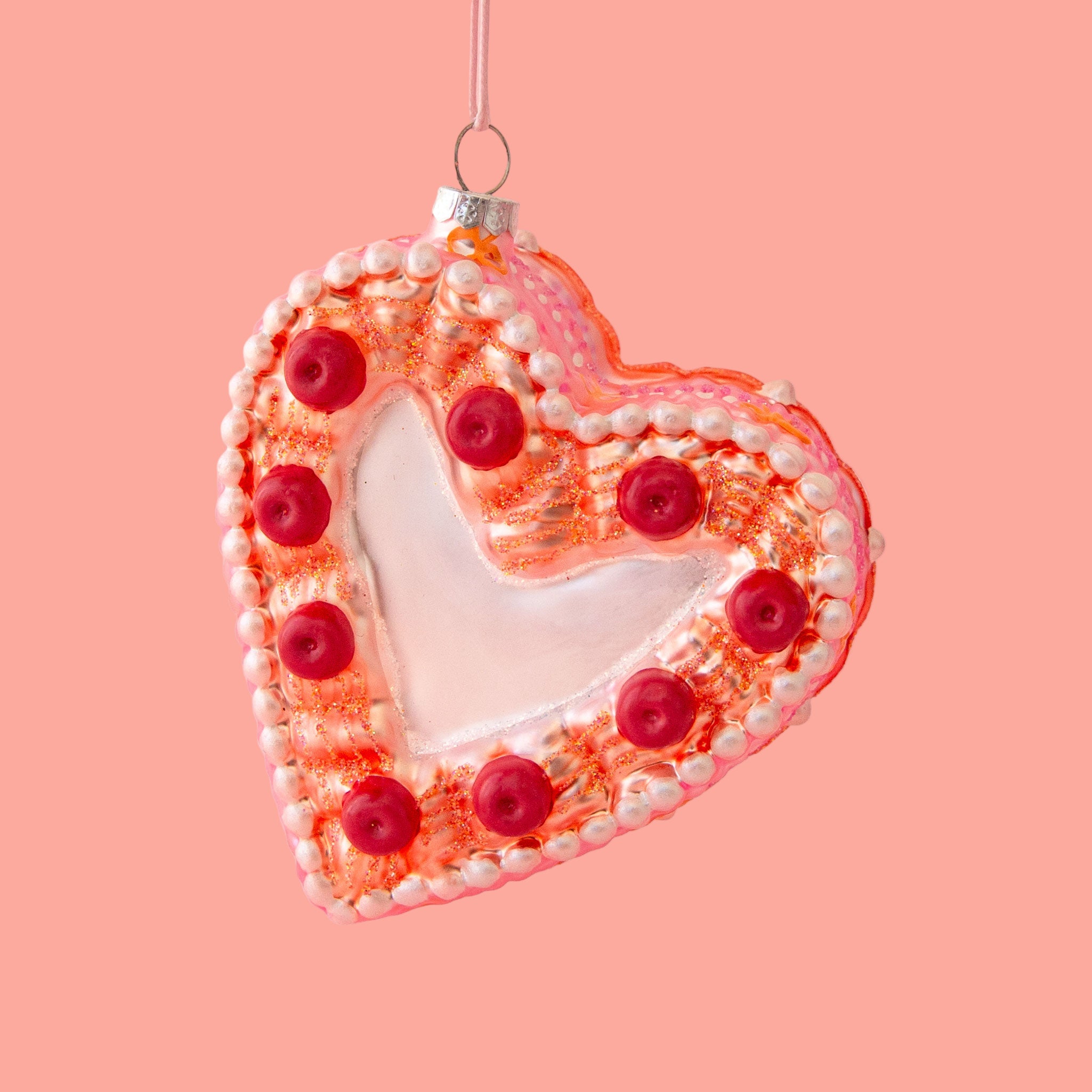 A vintage heart shaped cake ornament.