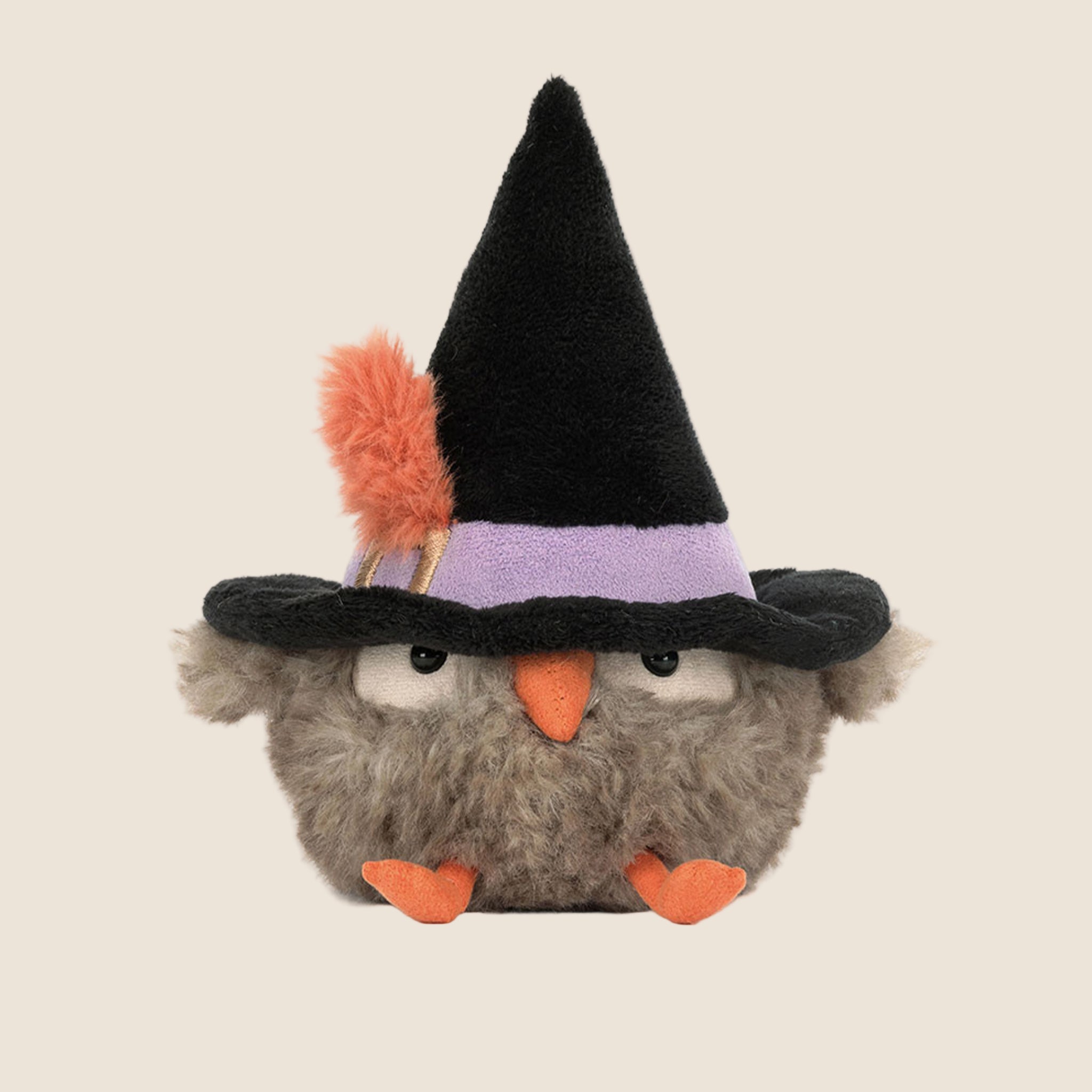 A little bird stuffed toy wearing a witch hat. 