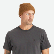 On a white background is a tan knit beanie with a label on the front cuff that reads, "Brixton".