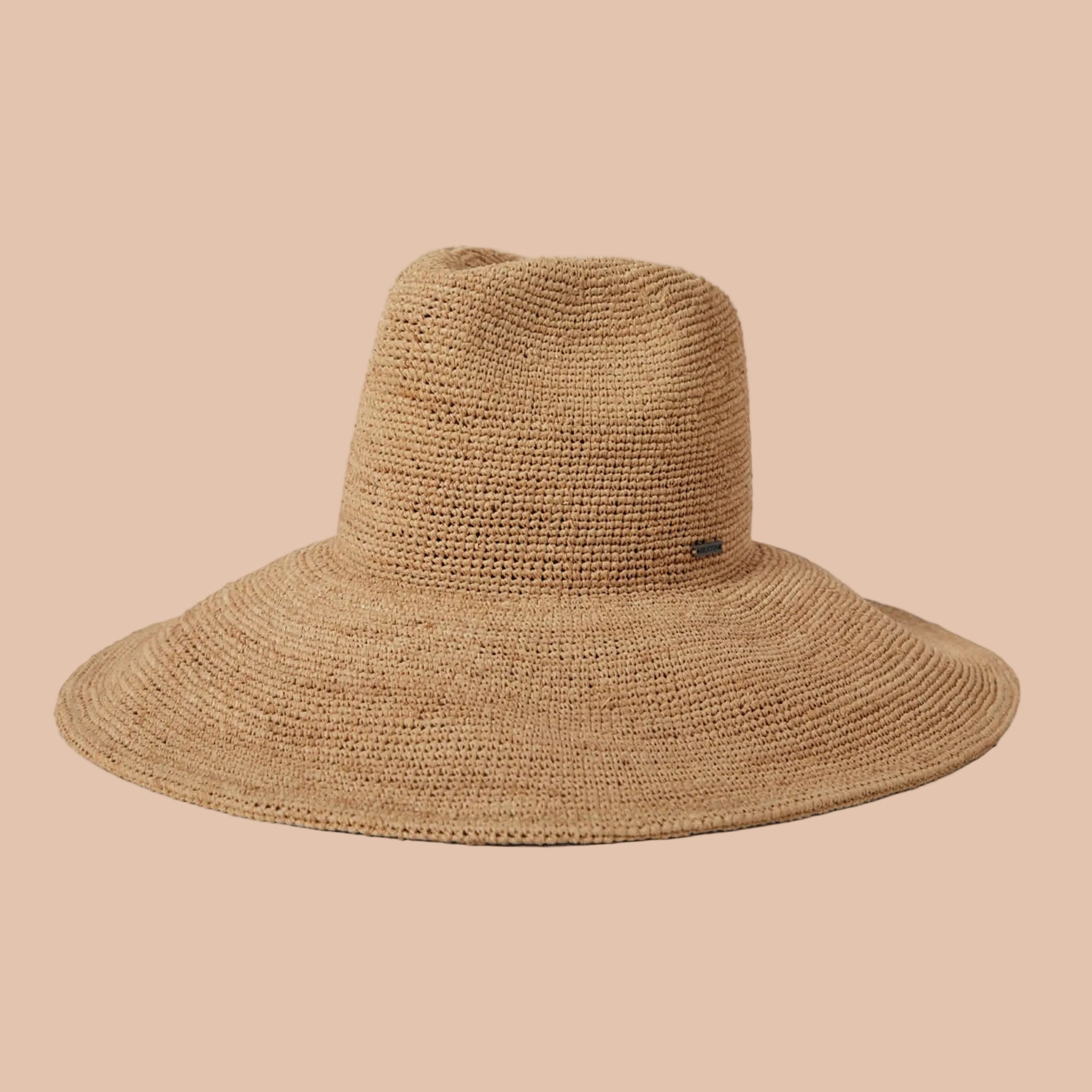 A tan straw foldable hat. 