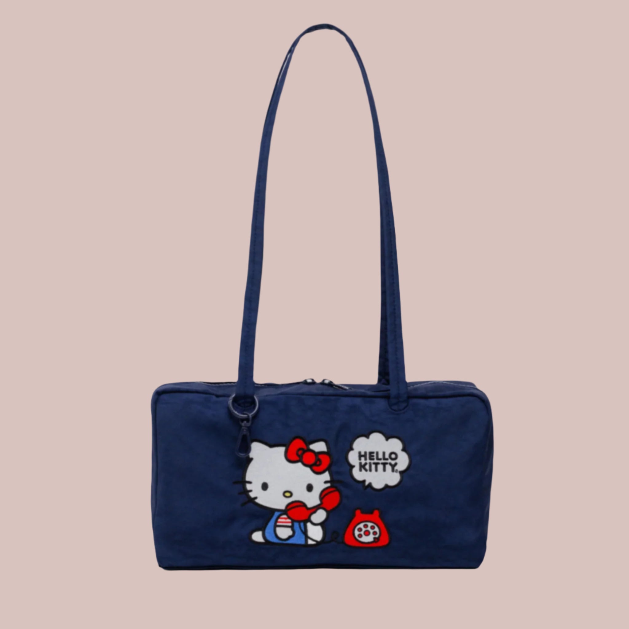 A dark blue nylon handbag with an embroidered hello kitty design. 