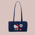 A dark blue nylon handbag with an embroidered hello kitty design. 