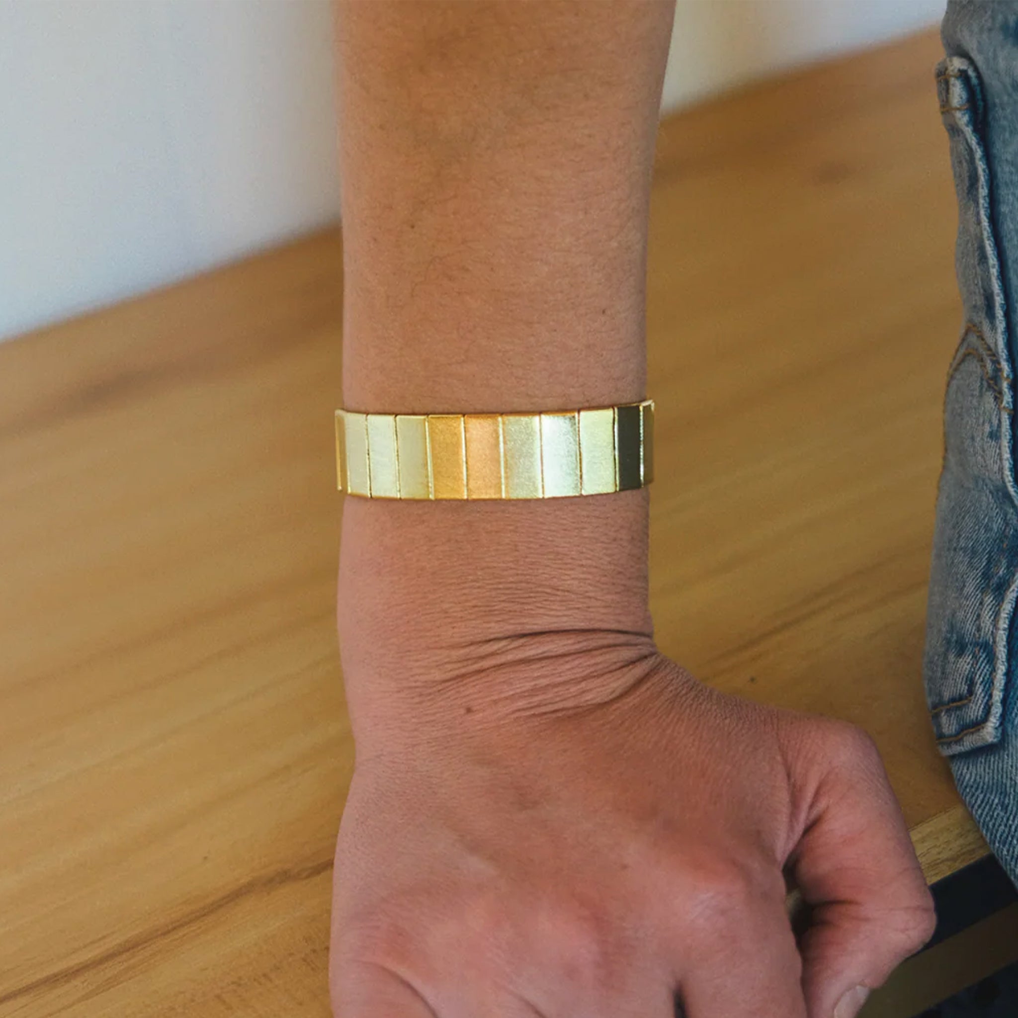 A chunky gold bracelet. 