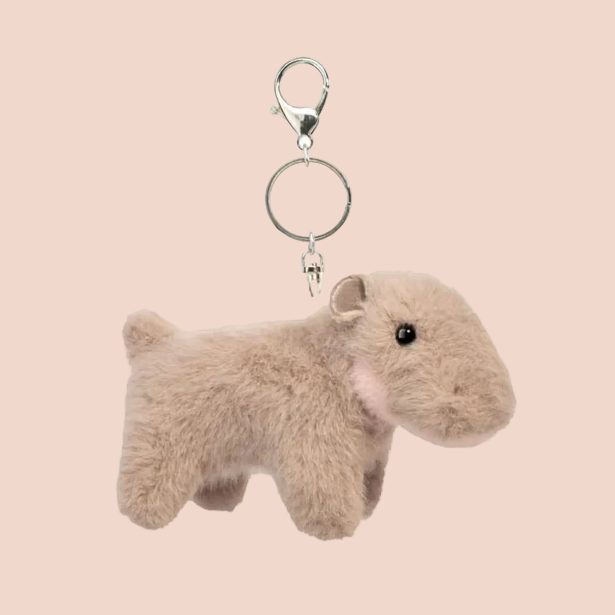 A mini hippo shaped stuffed toy on a keychain.