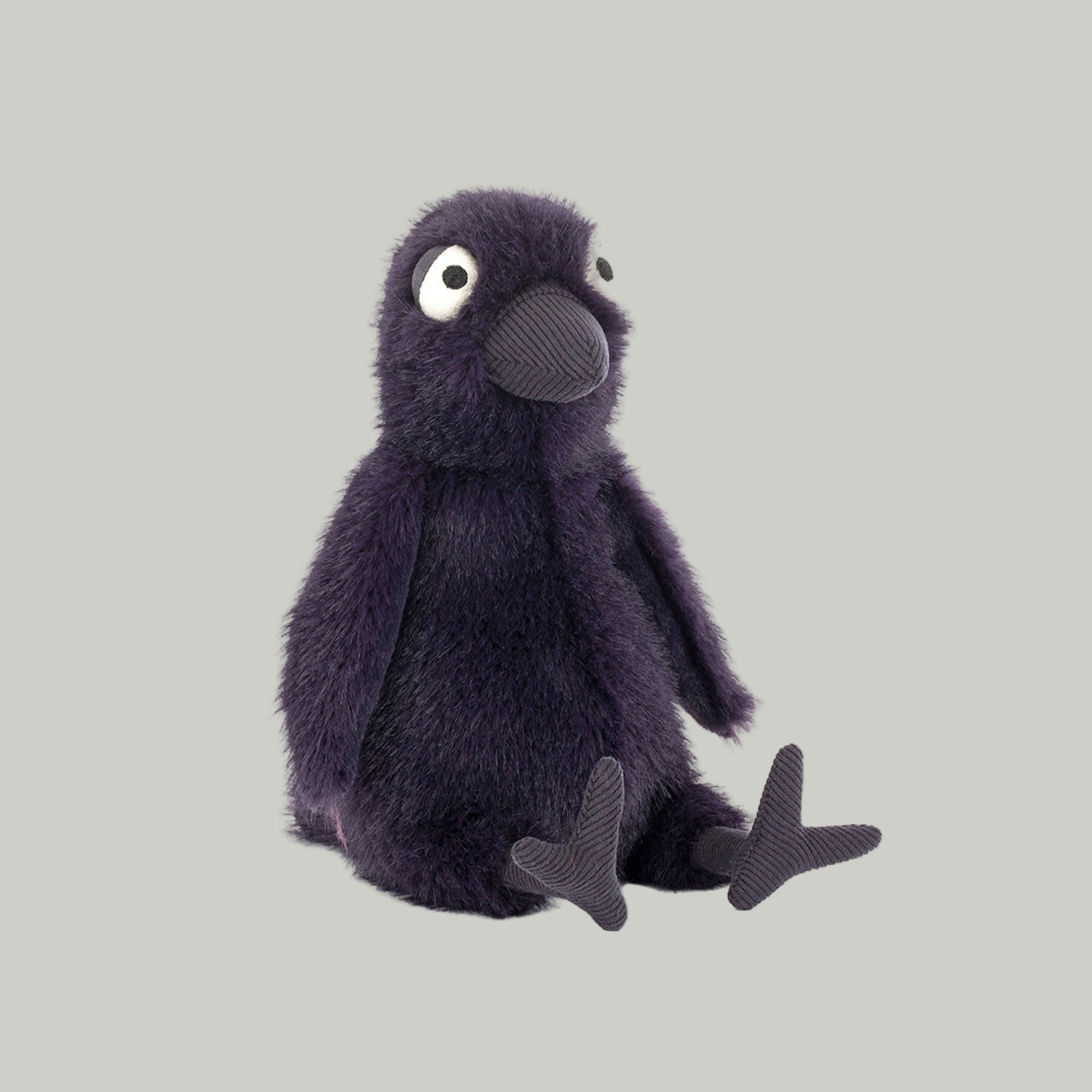 A black crow shaped stuffed toy. 
