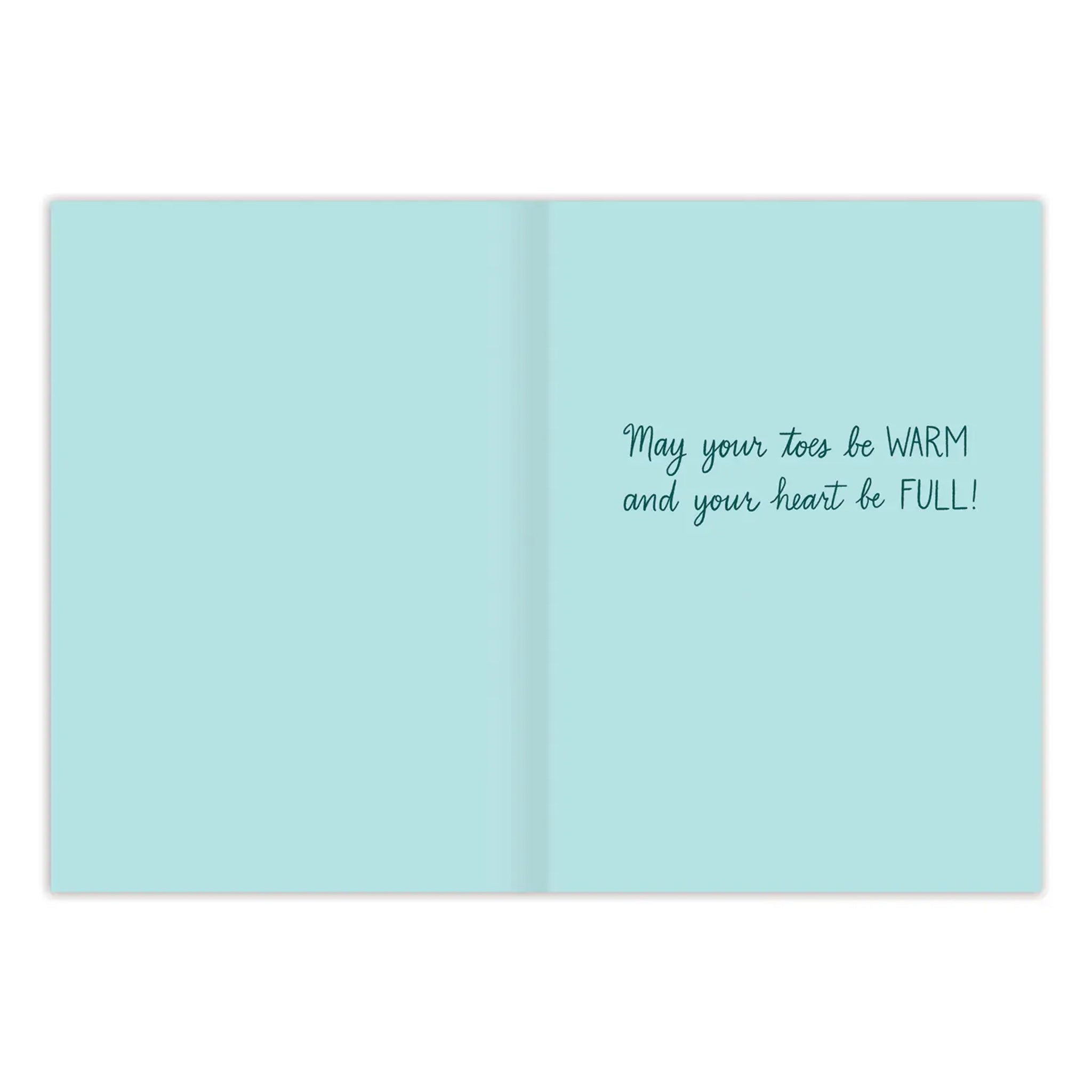 A card with an illustration of a forest and someone walking their dog along with text that reads, 'Enjoy the Beauty of the Season' and an inside message that reads, 'May your toes be warm and your heart be full'. 