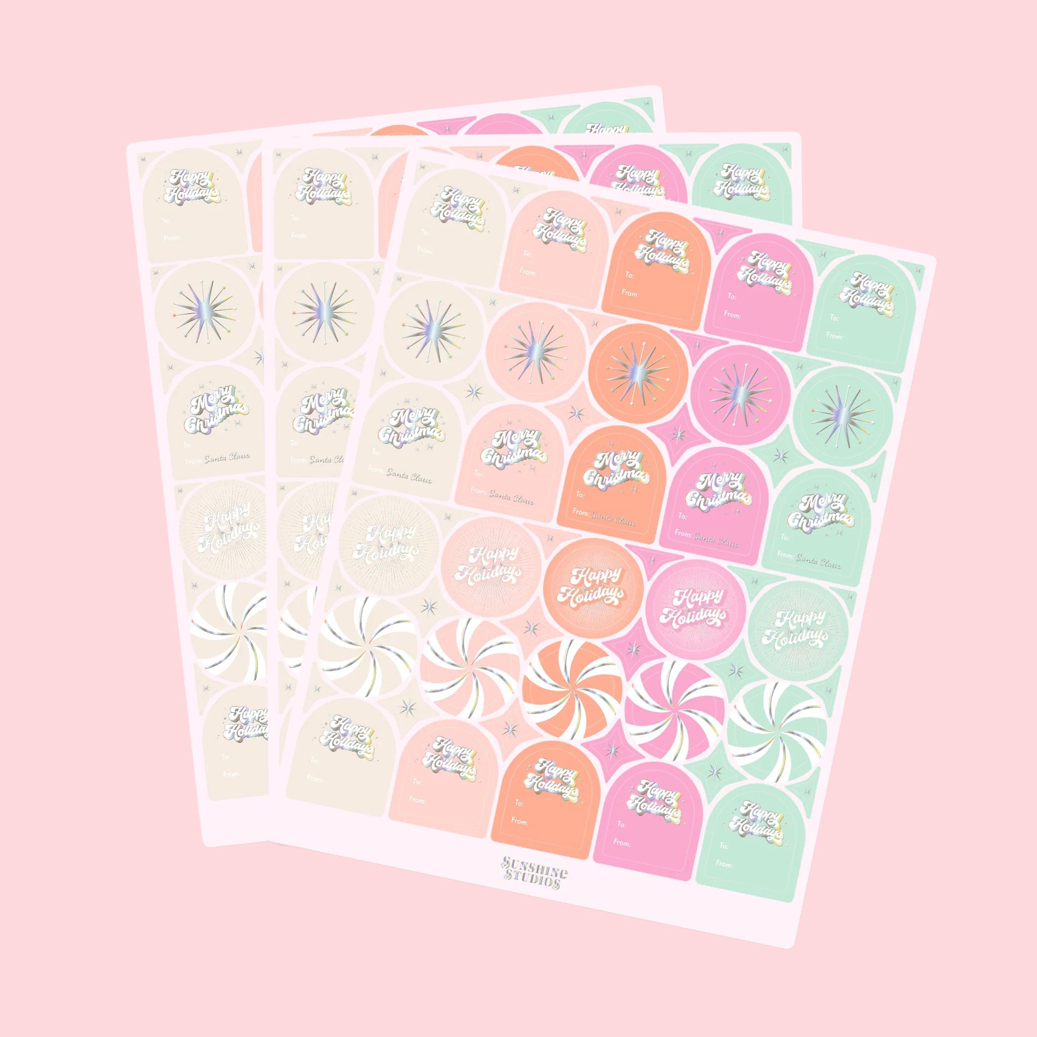 On a pink background is three sheets of gift labels with shades of pink, orange, mint and ivory along with holographic text and designs.